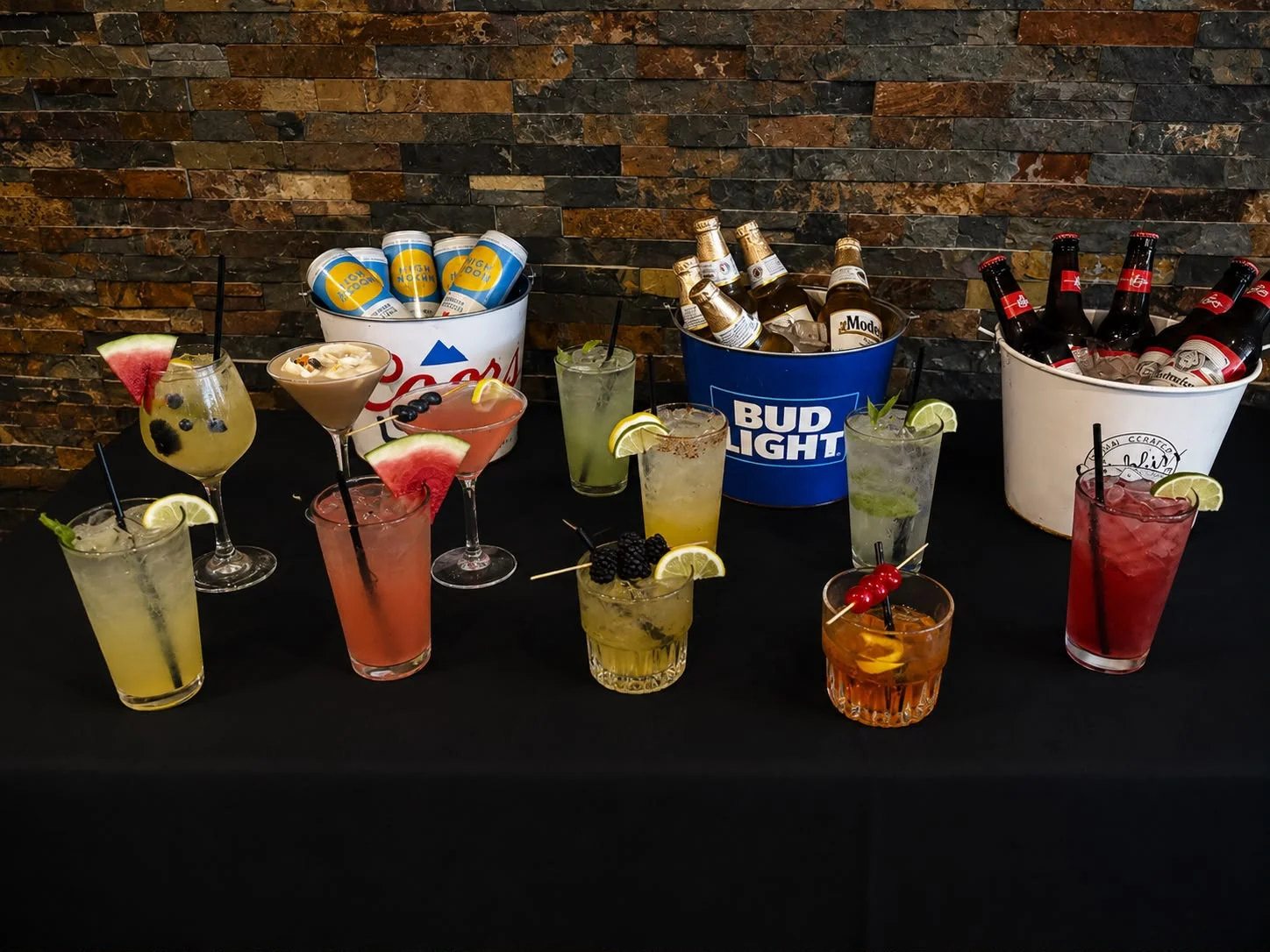 Colorful cocktails and beers displayed on a bar counter