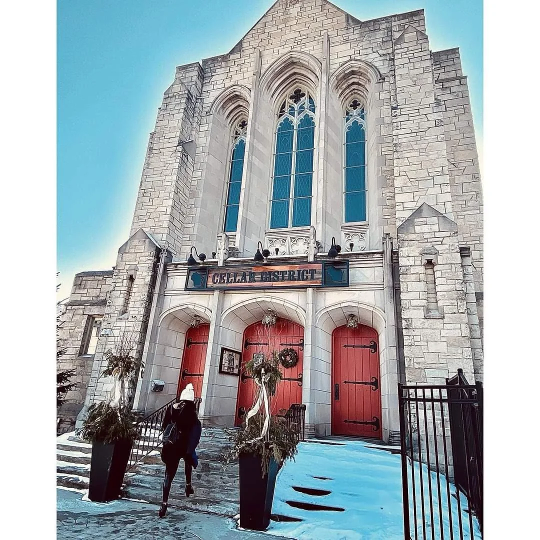 Historic building exterior with red doors and winter decor