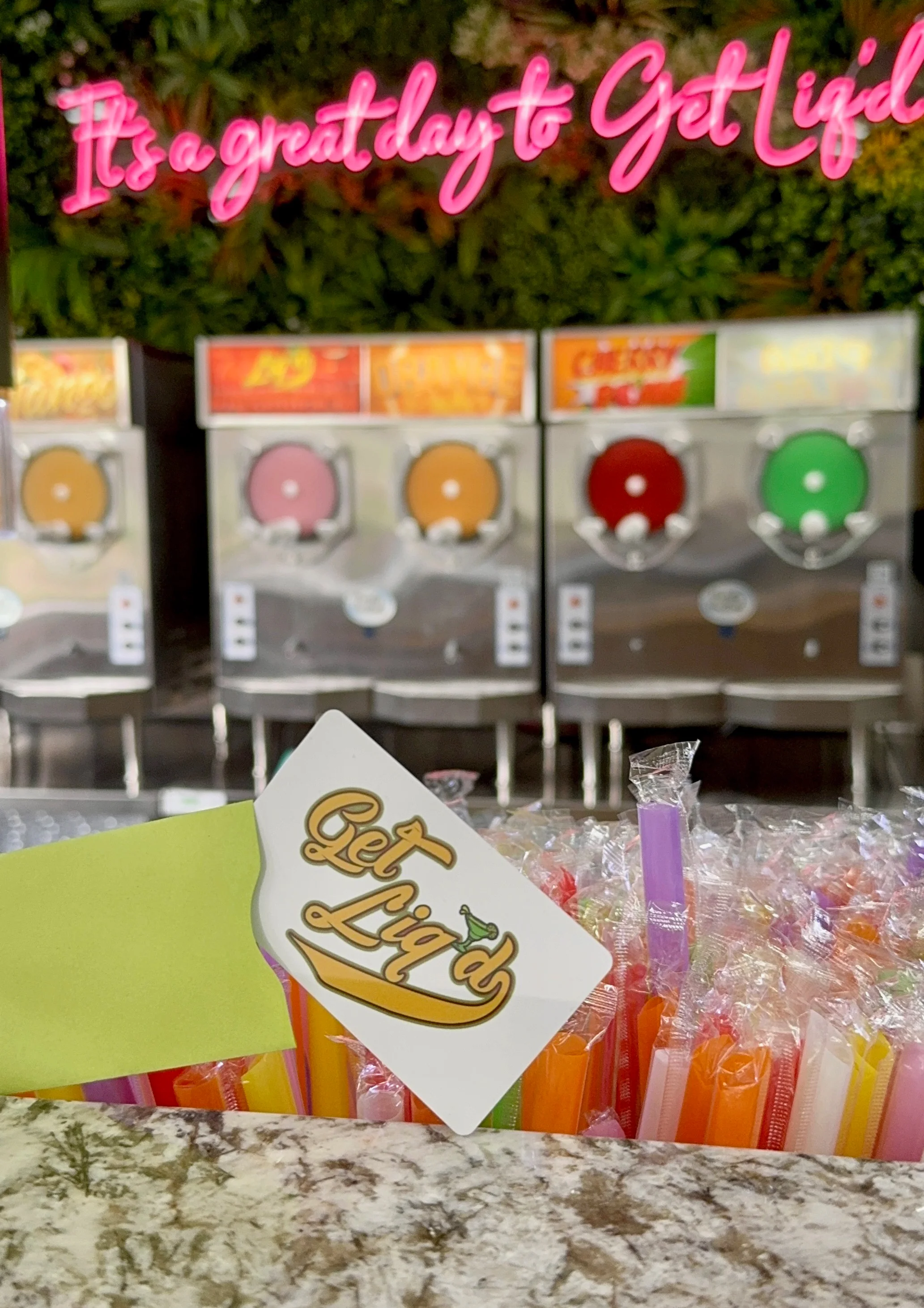 Colorful slushie machines in a vibrant bar setting