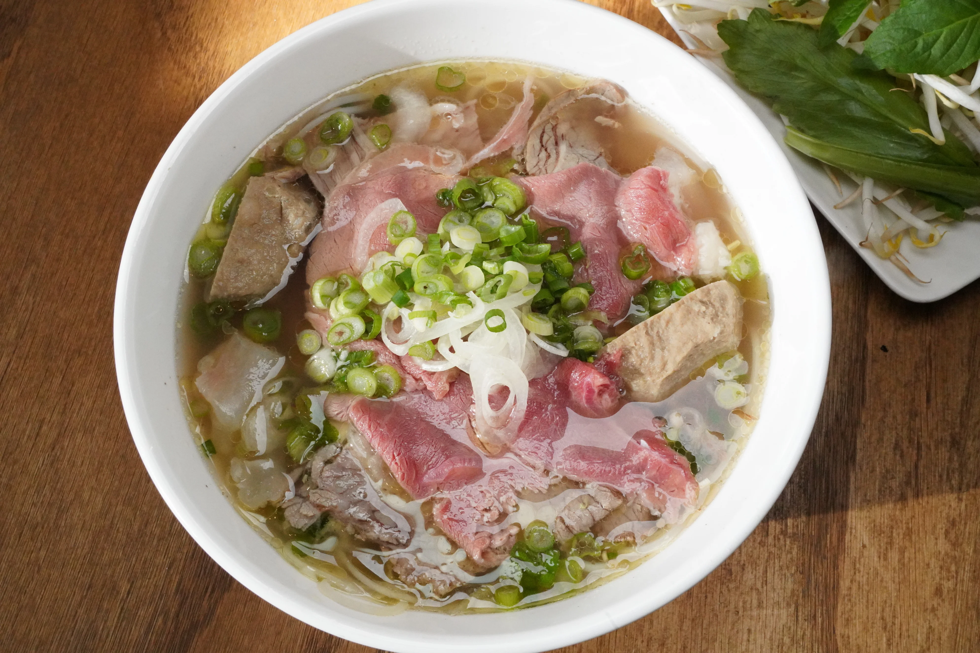 Bowl of Vietnamese pho with beef and green onions