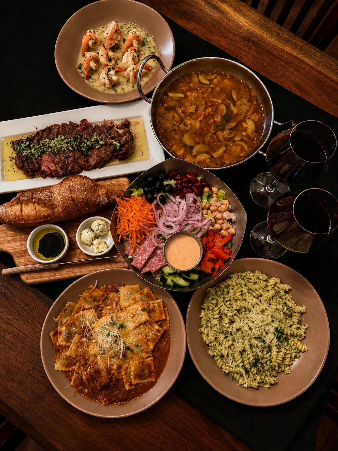 Assorted international dishes including ravioli and grilled steak