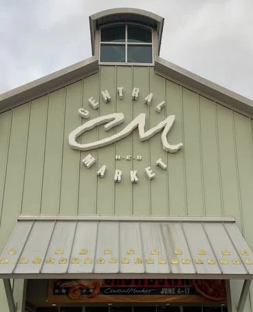 Entrance of Central Market grocery store with green exterior
