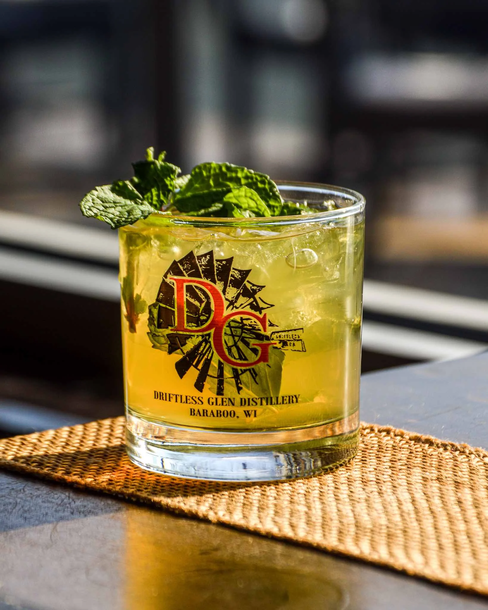 Sunshine & Whiskey cocktail on a barrel at Driftless Glen