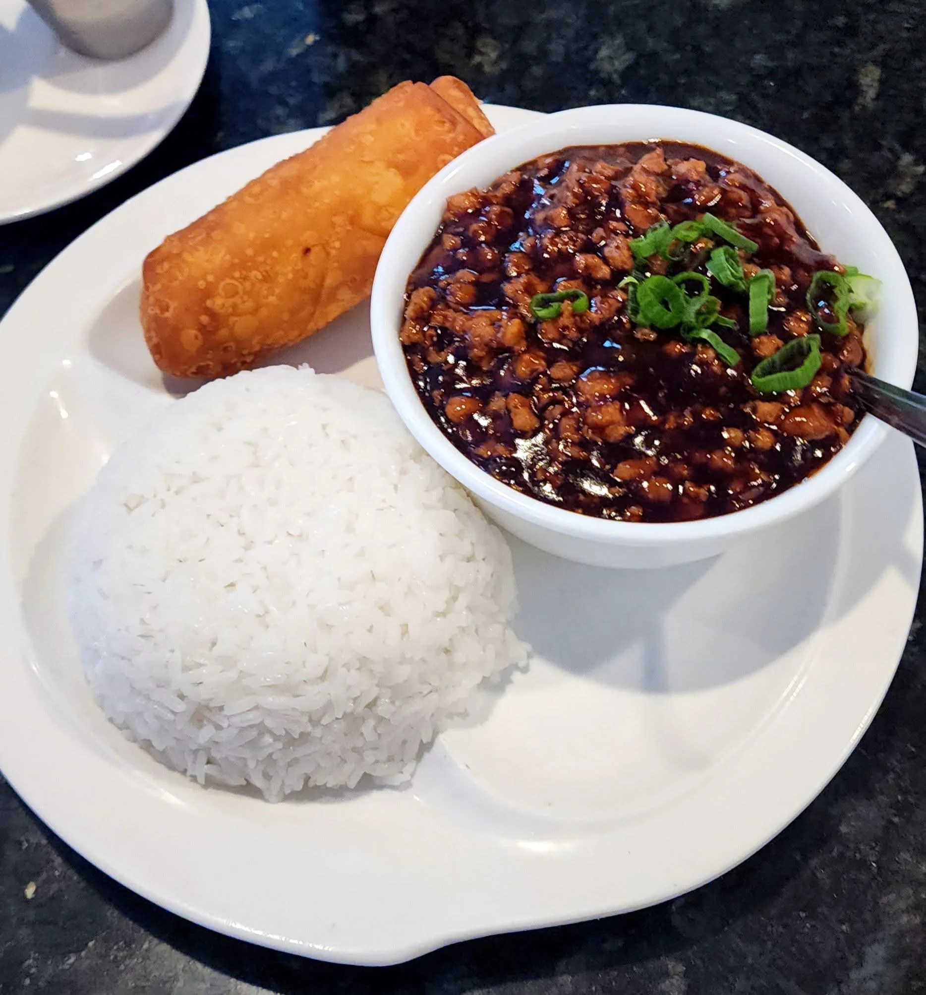 Savory Chinese mapo tofu with steamed rice and spring roll