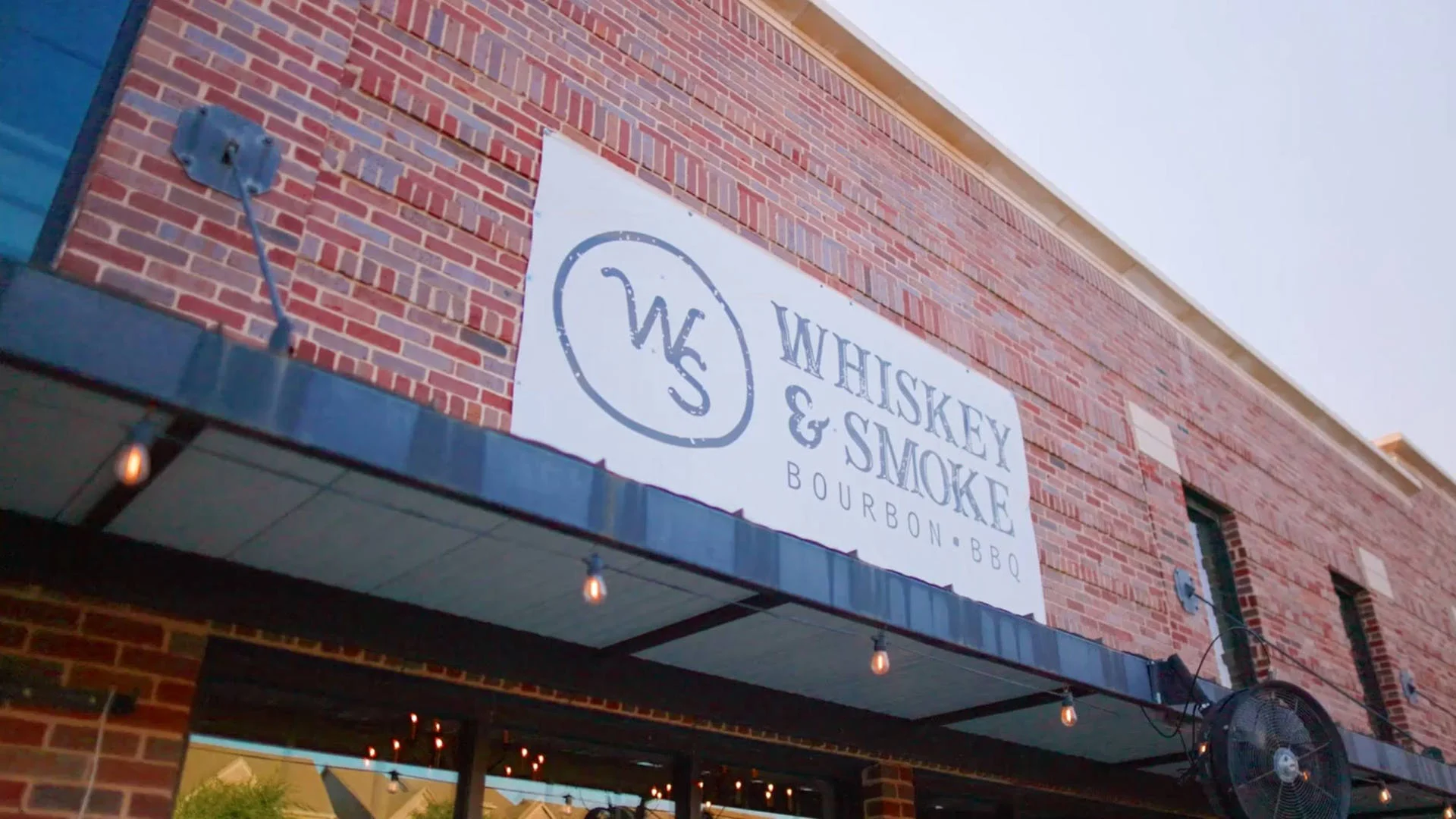 Exterior view of Whiskey & Smoke restaurant with brick facade