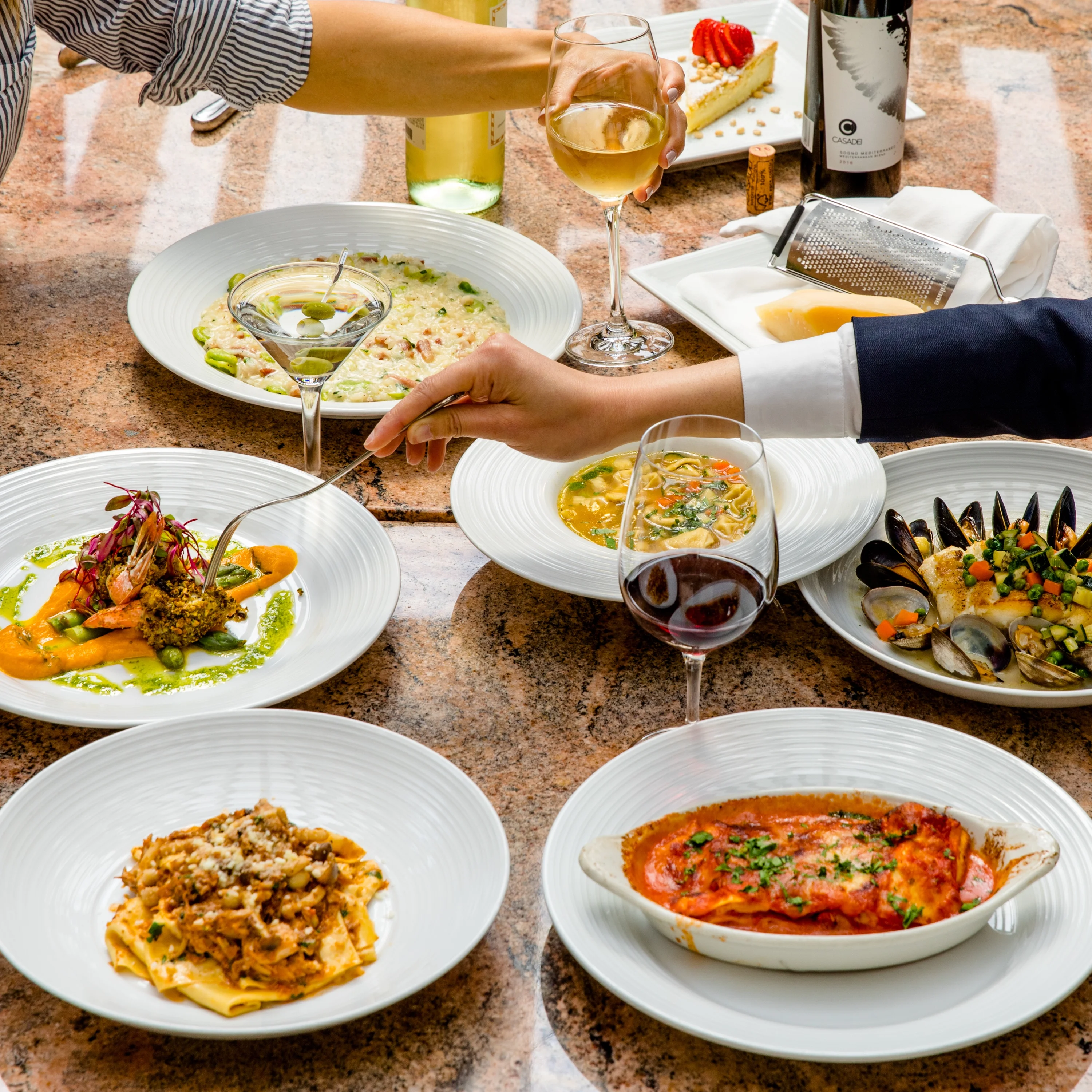Elegant dining spread featuring Italian lasagna and seafood dishes