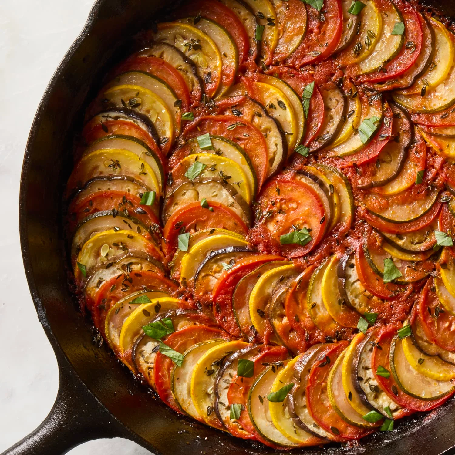 Colorful ratatouille baked in a cast iron skillet