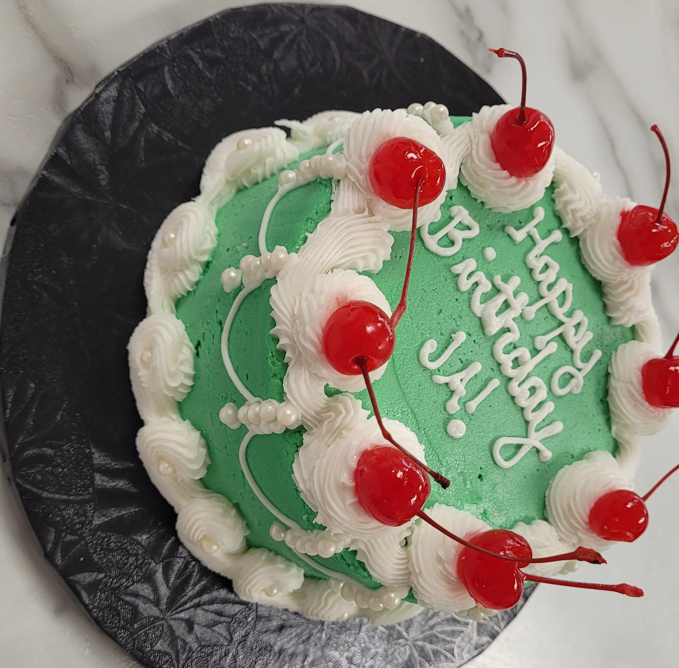 Colorful birthday cake with cherries and frosting