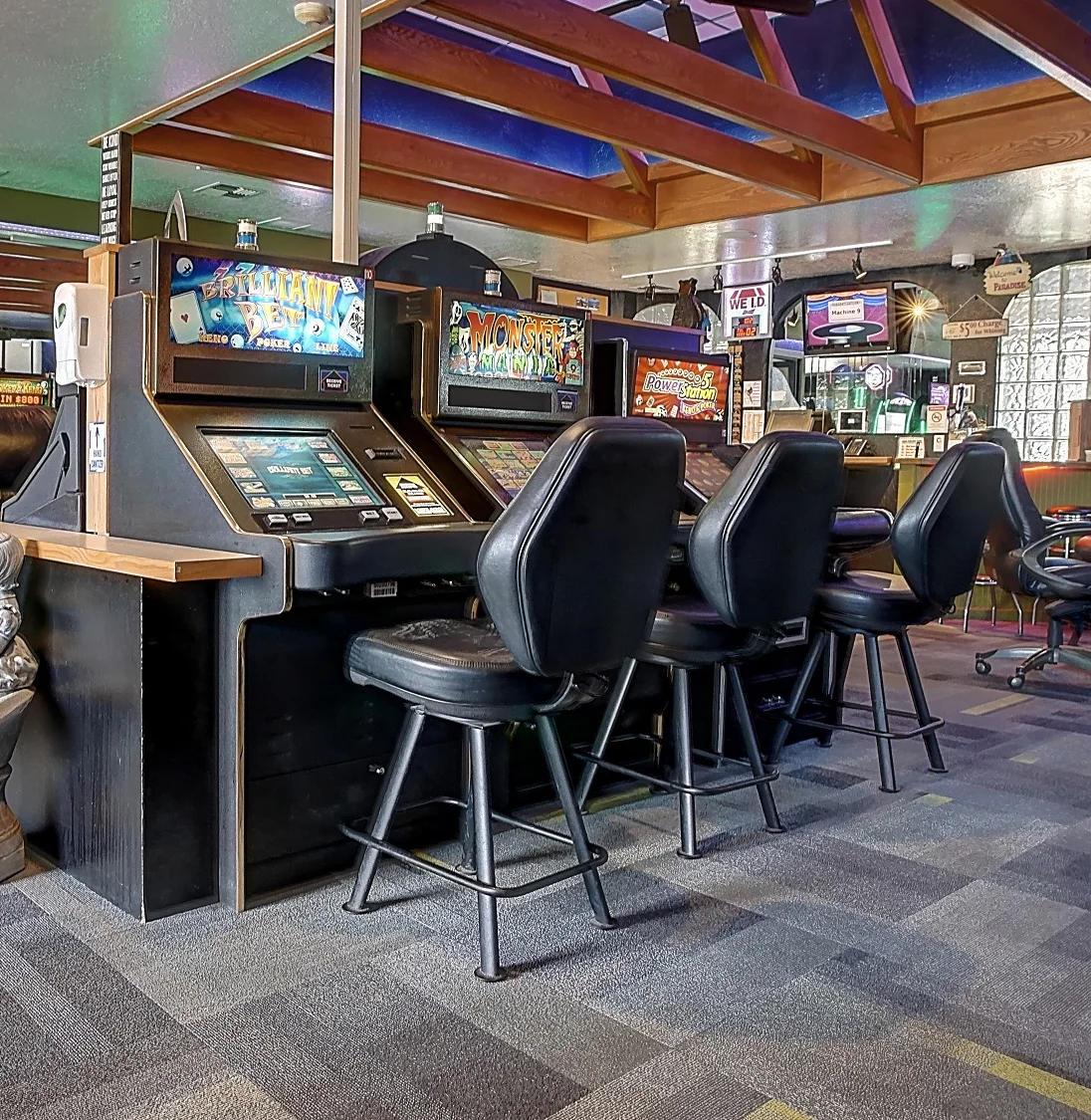 Interior of a gaming lounge with slot machines and seating