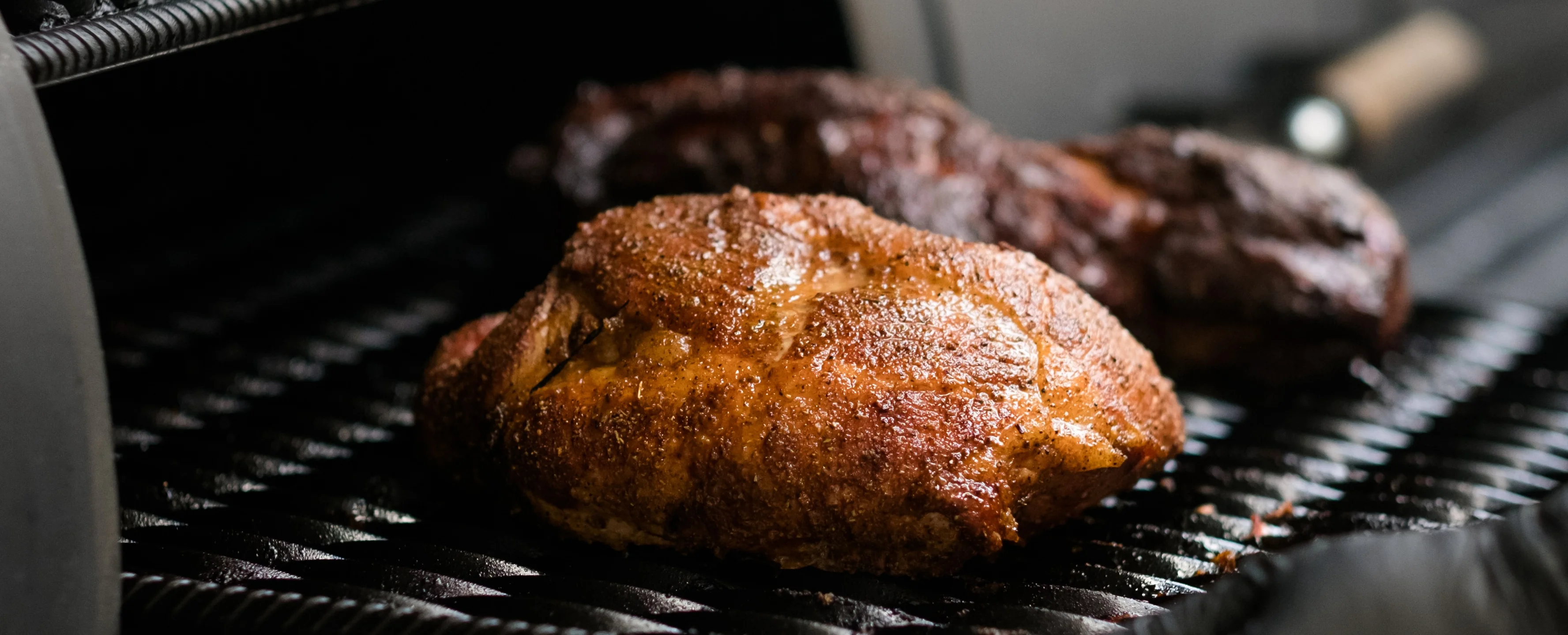 Smoked brisket and ribs in a BBQ smoker
