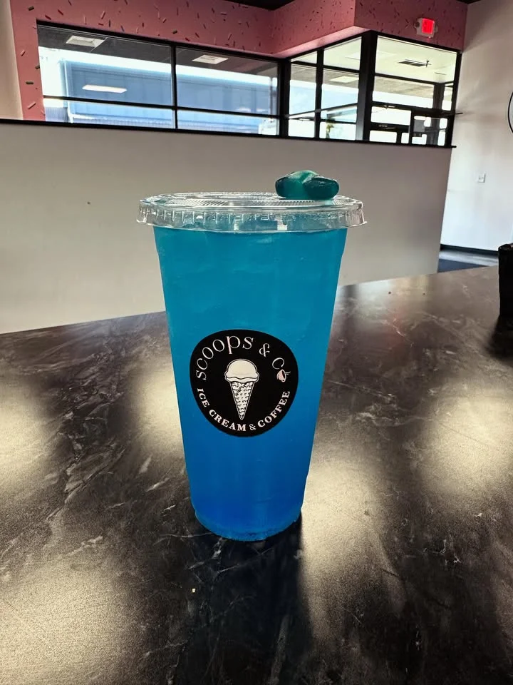 Refreshing blue drink in a clear cup at an ice cream shop