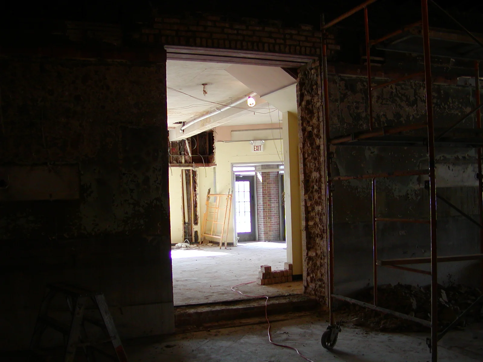Construction site showing an open doorway and scaffolding in a restaurant renovation