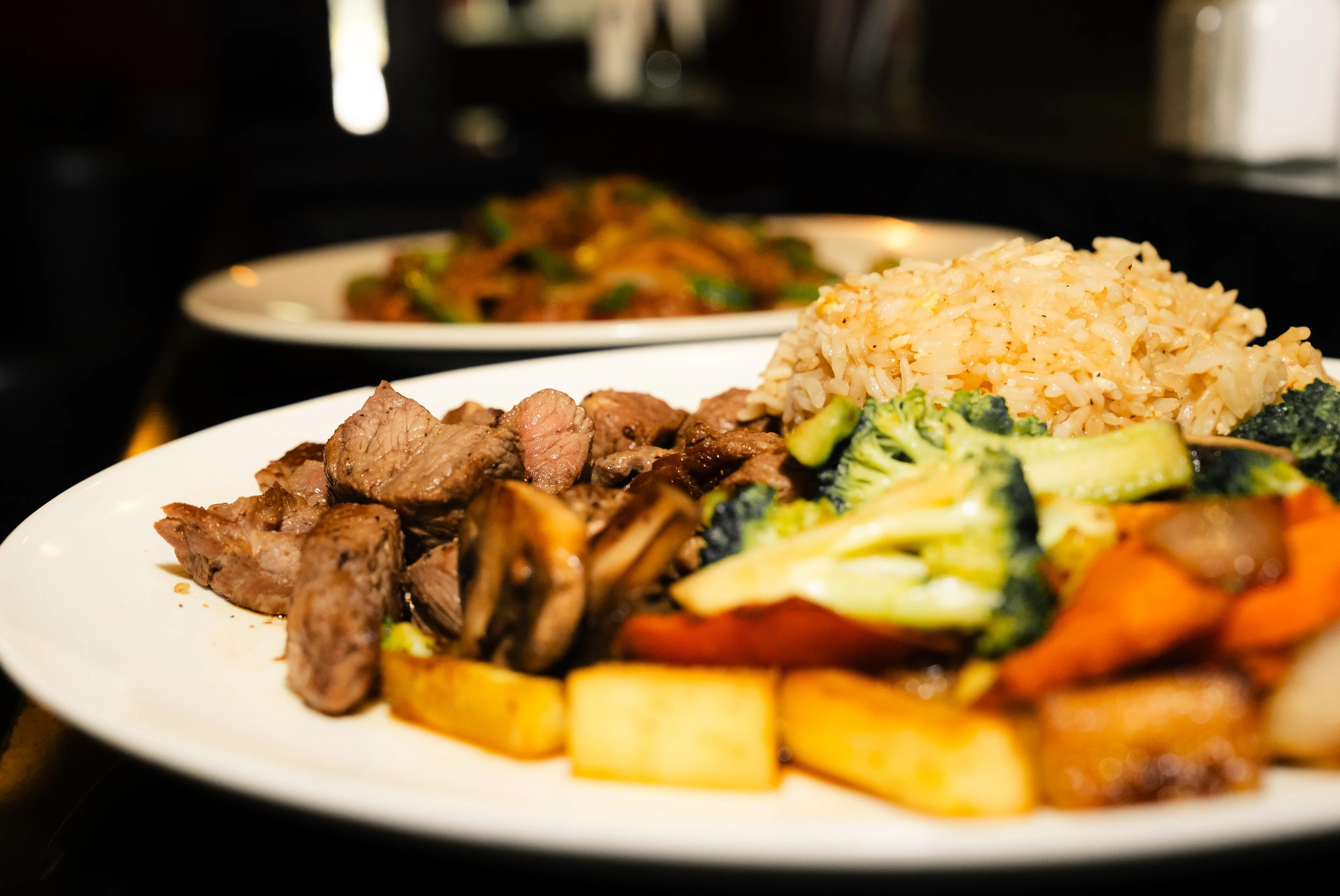 Grilled steak with rice and sautéed vegetables