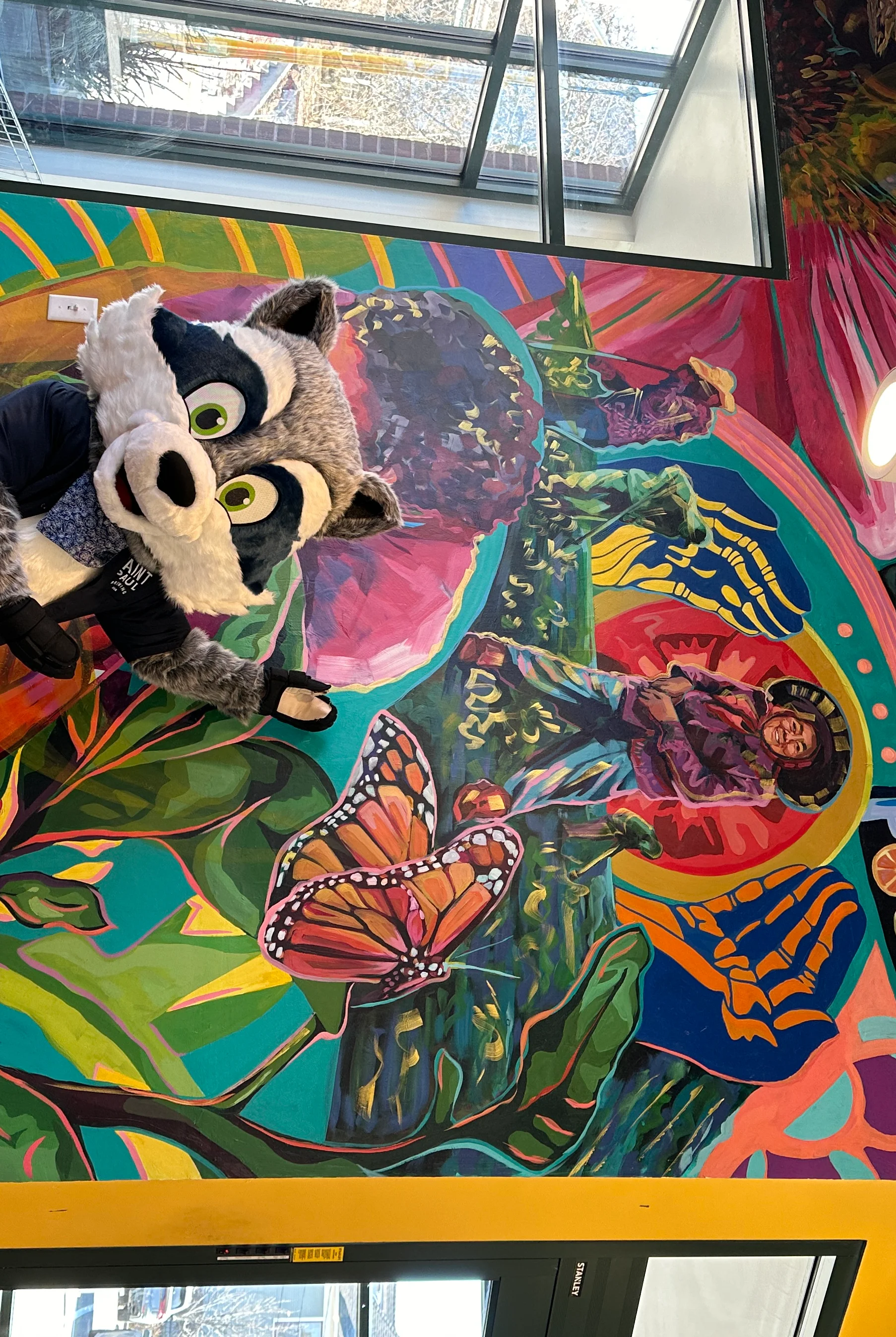 Colorful mural in a restaurant with a raccoon mascot