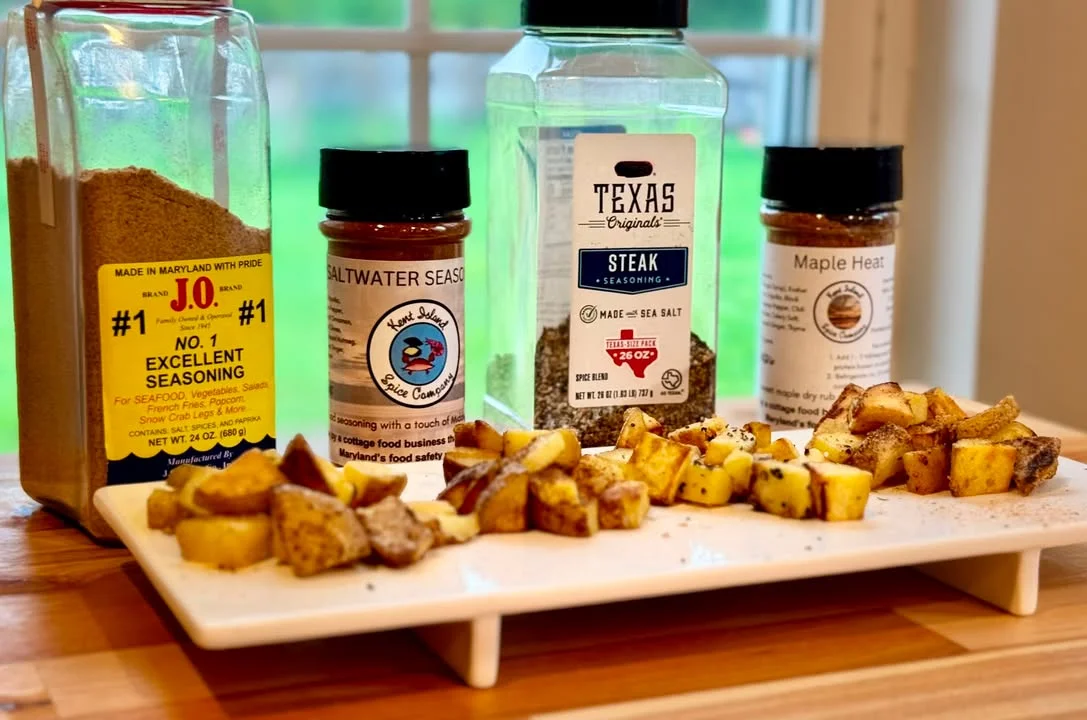 Seasoned roasted potatoes with various spice blends on a wooden platter