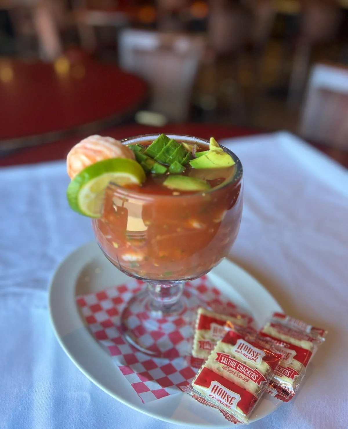 Refreshing Mexican shrimp cocktail in a glass with garnishes