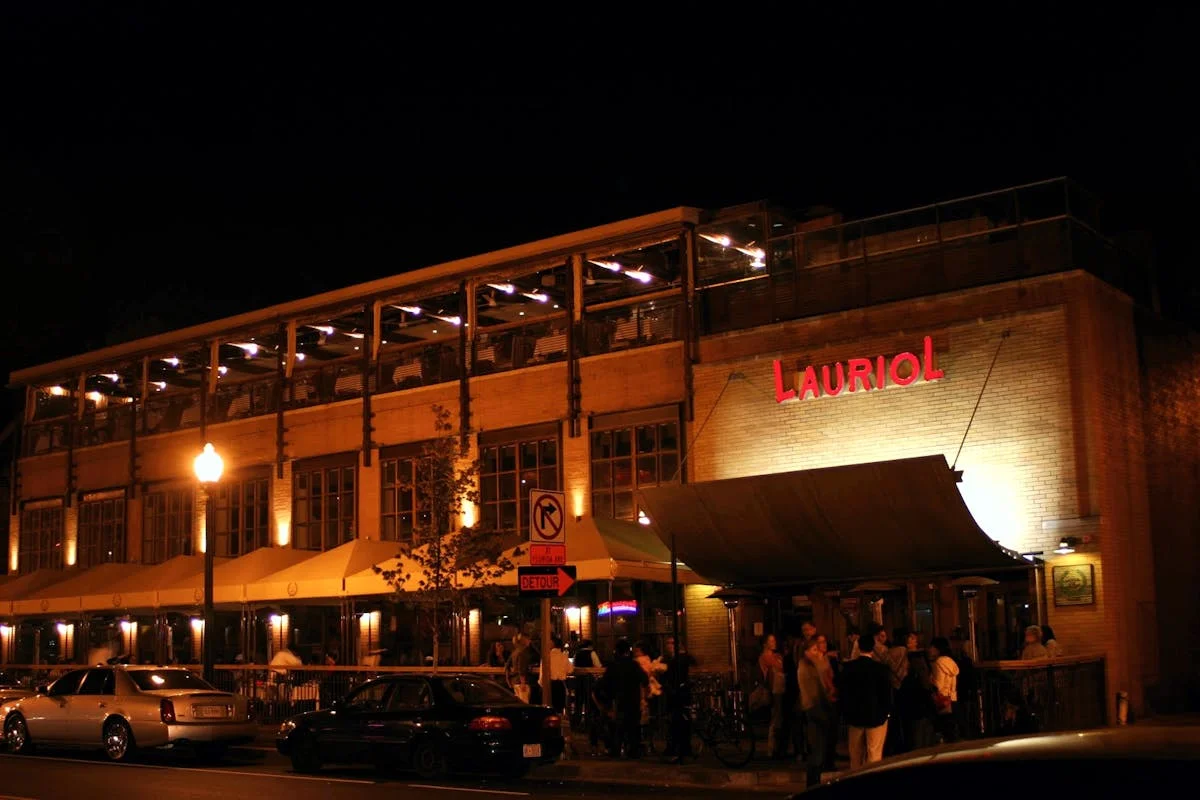 Vibrant restaurant exterior at night with warm lighting