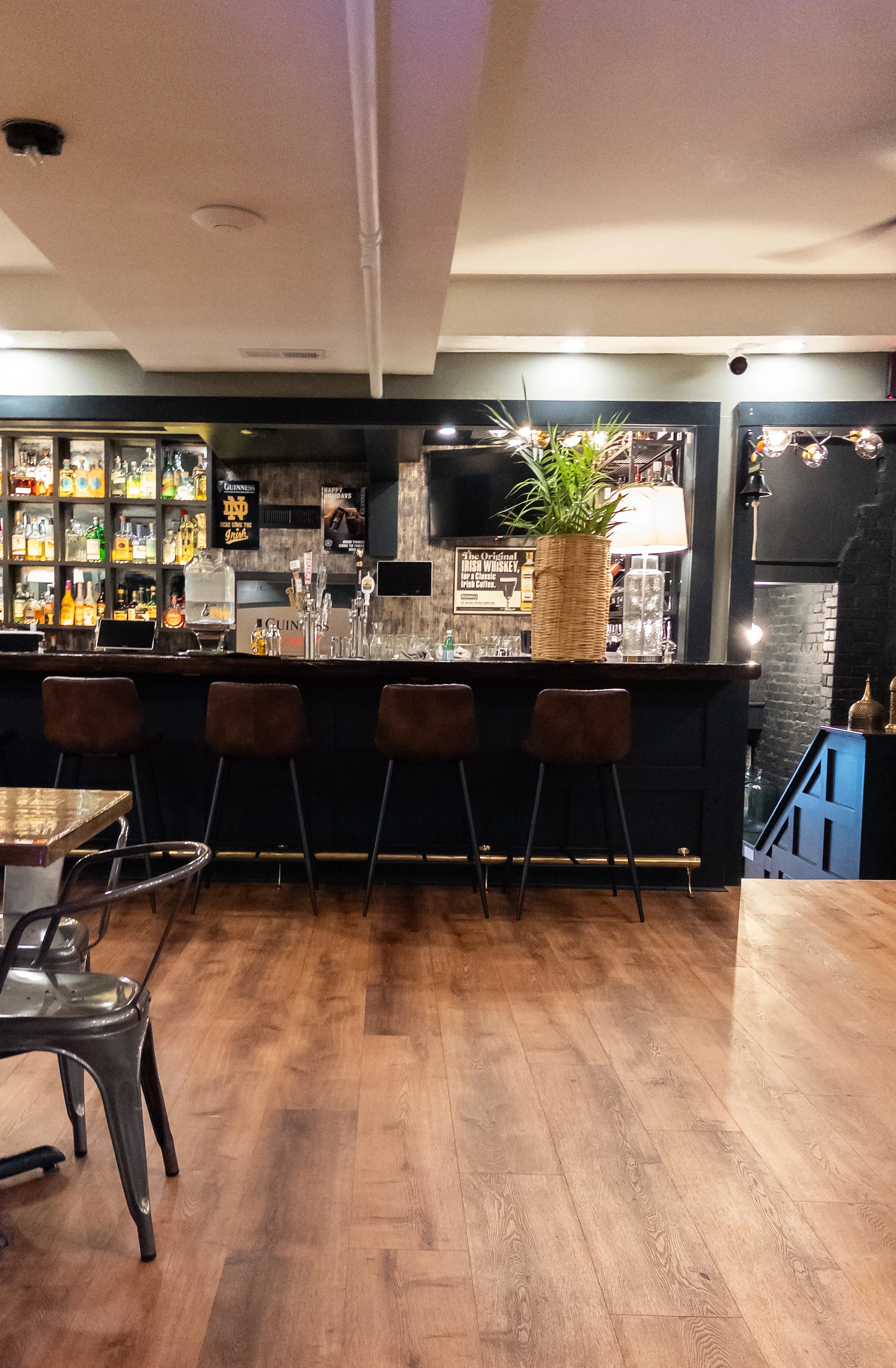 Modern bar interior with stylish seating and shelves of spirits