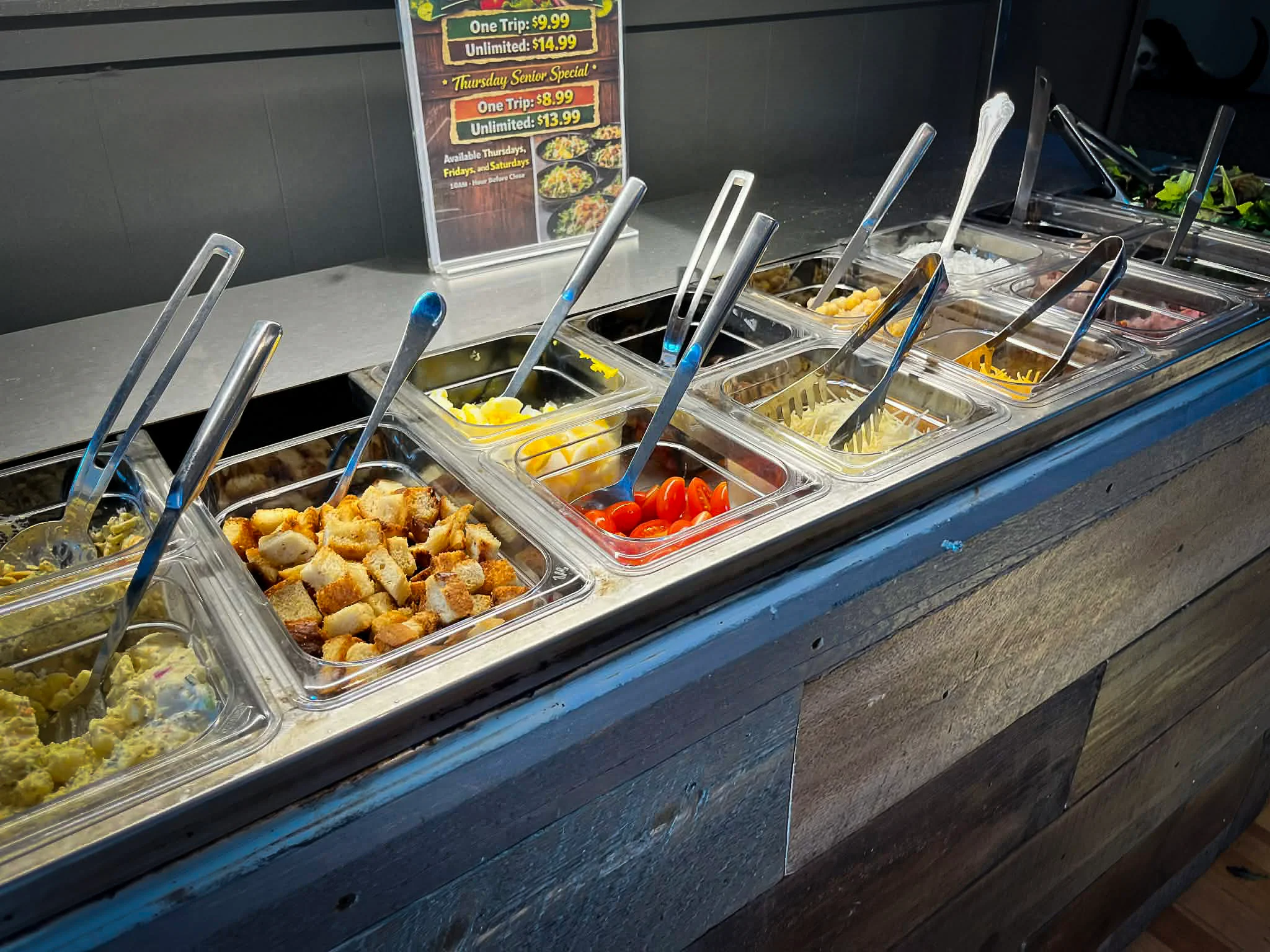 Salad bar with various toppings and dressings