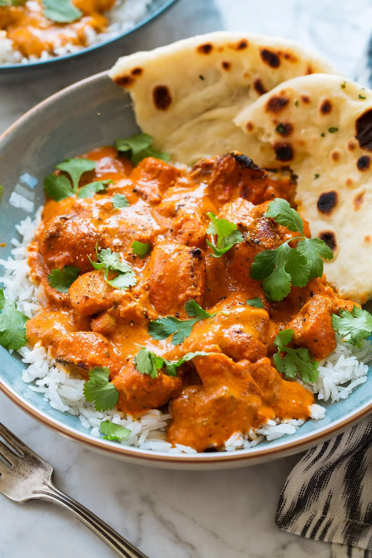 Creamy butter chicken served with basmati rice and naan bread