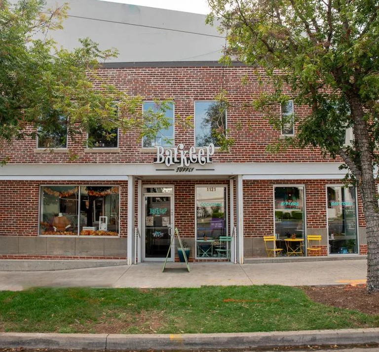 Charming storefront of a bar supply shop with outdoor seating