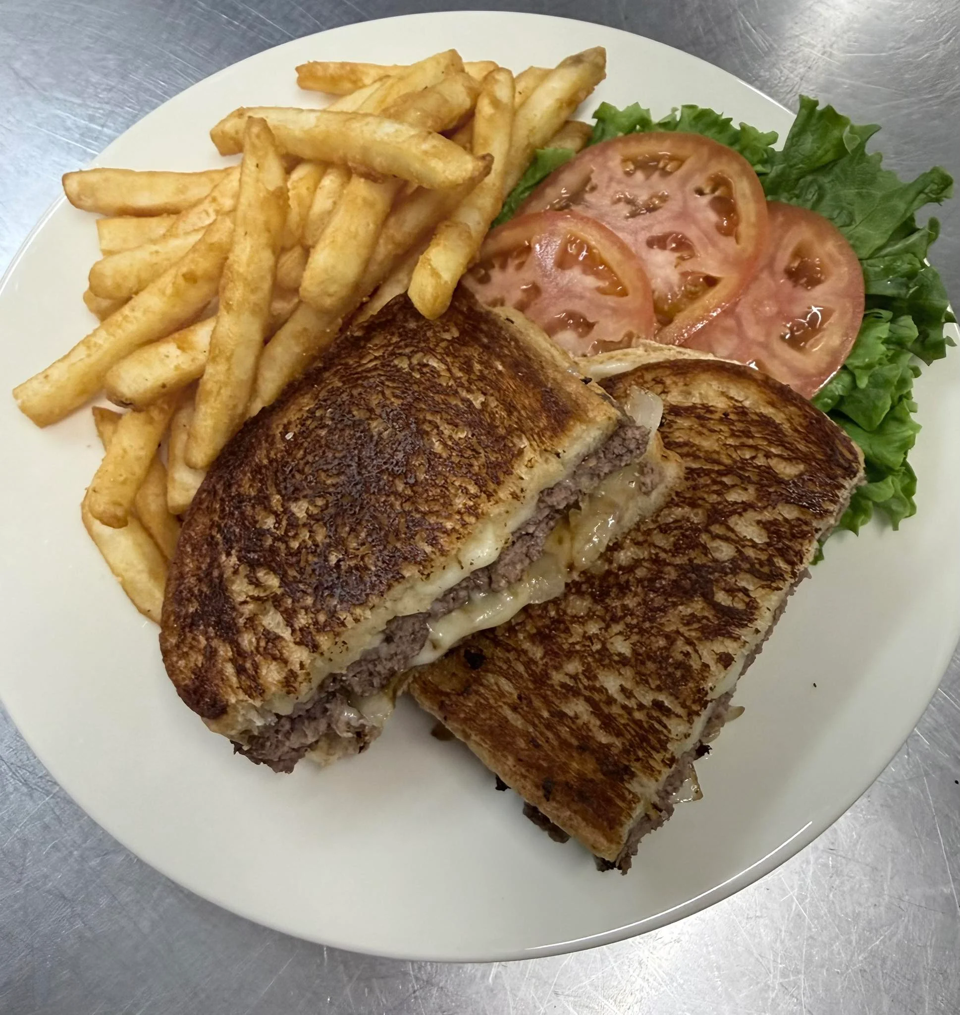 Delicious cheeseburger melt with melted cheese and grilled onions on toasted bread.