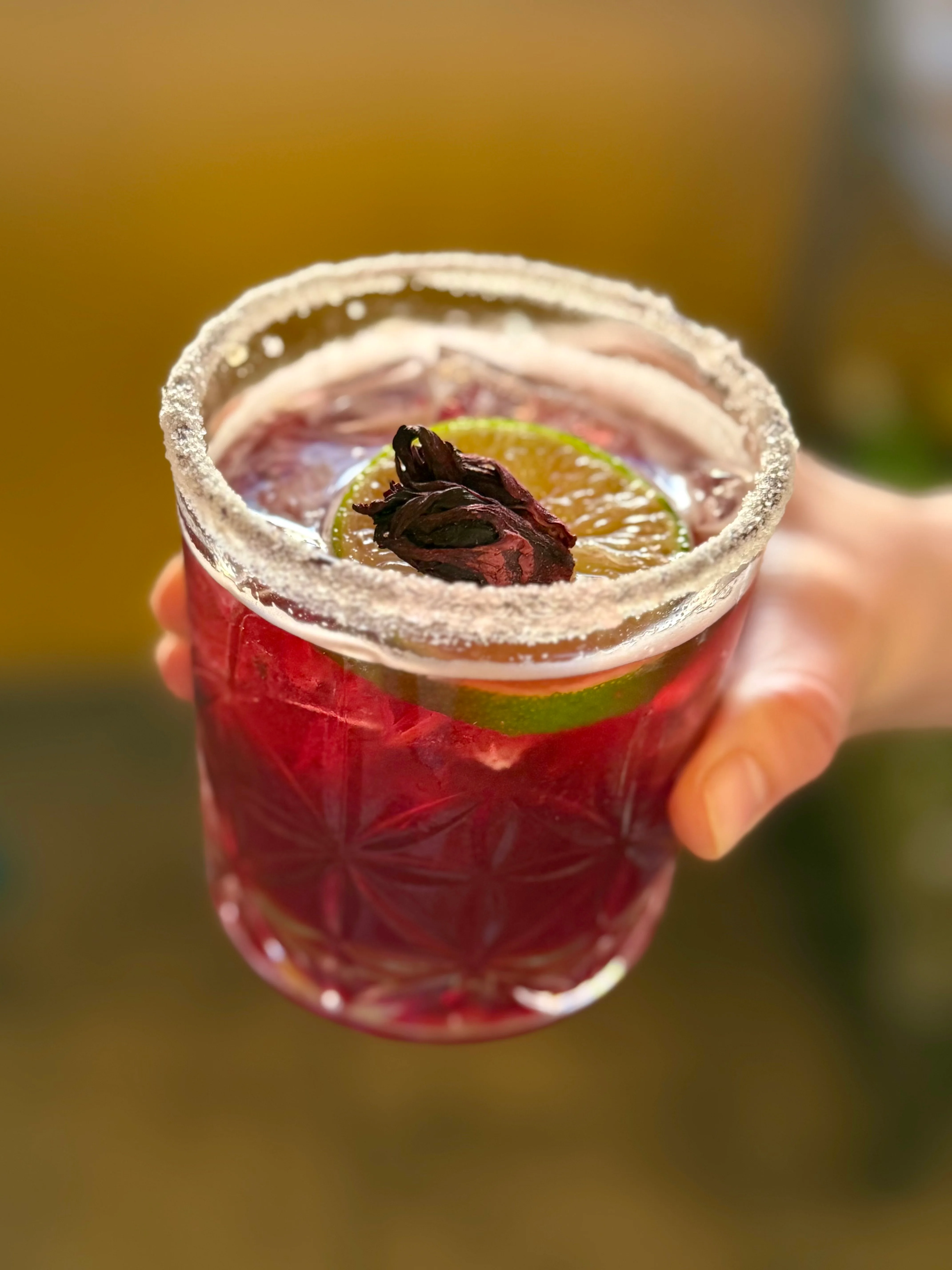 Refreshing hibiscus cocktail with lime garnish