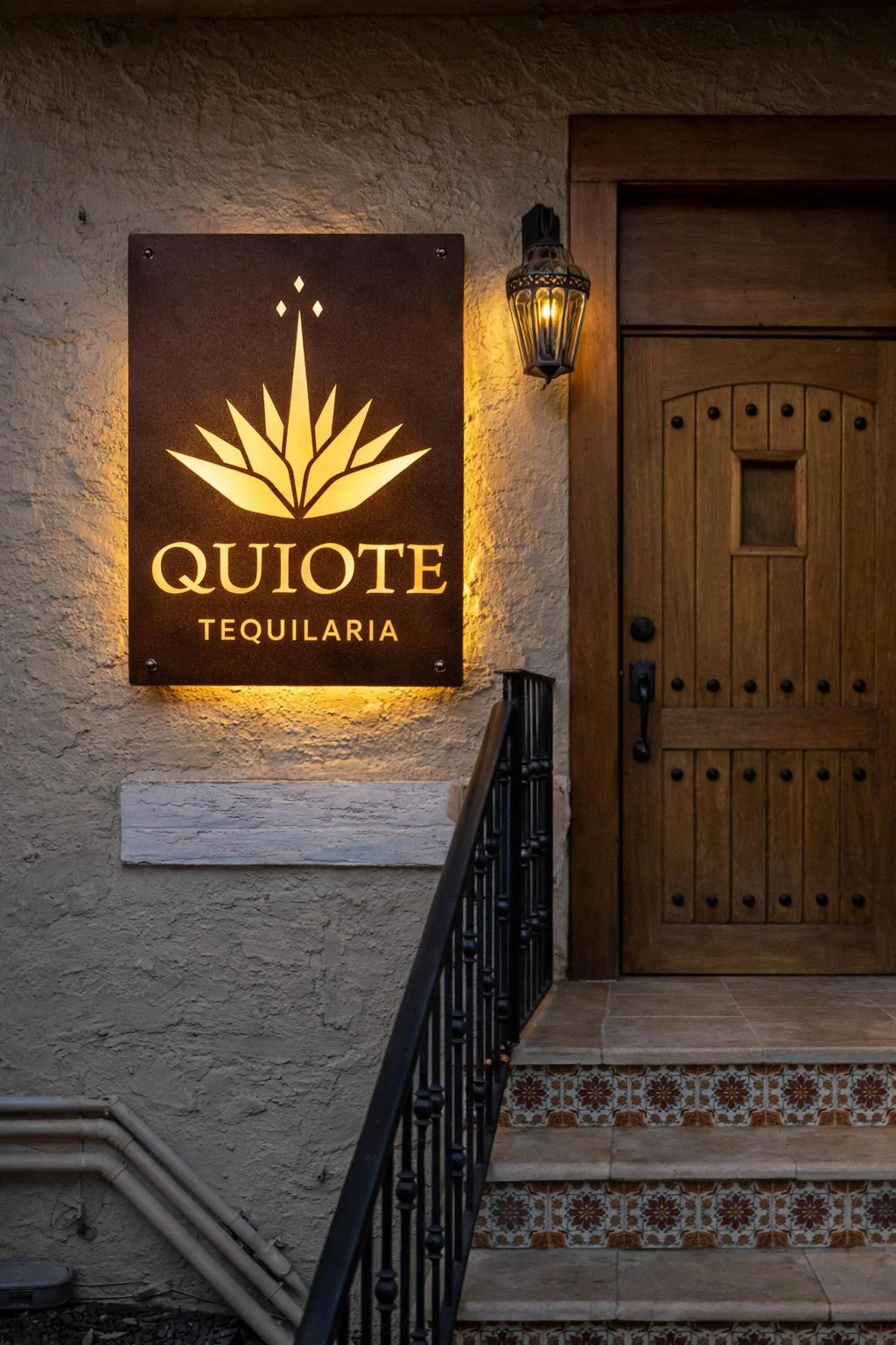 Tequila bar entrance with illuminated sign and rustic decor