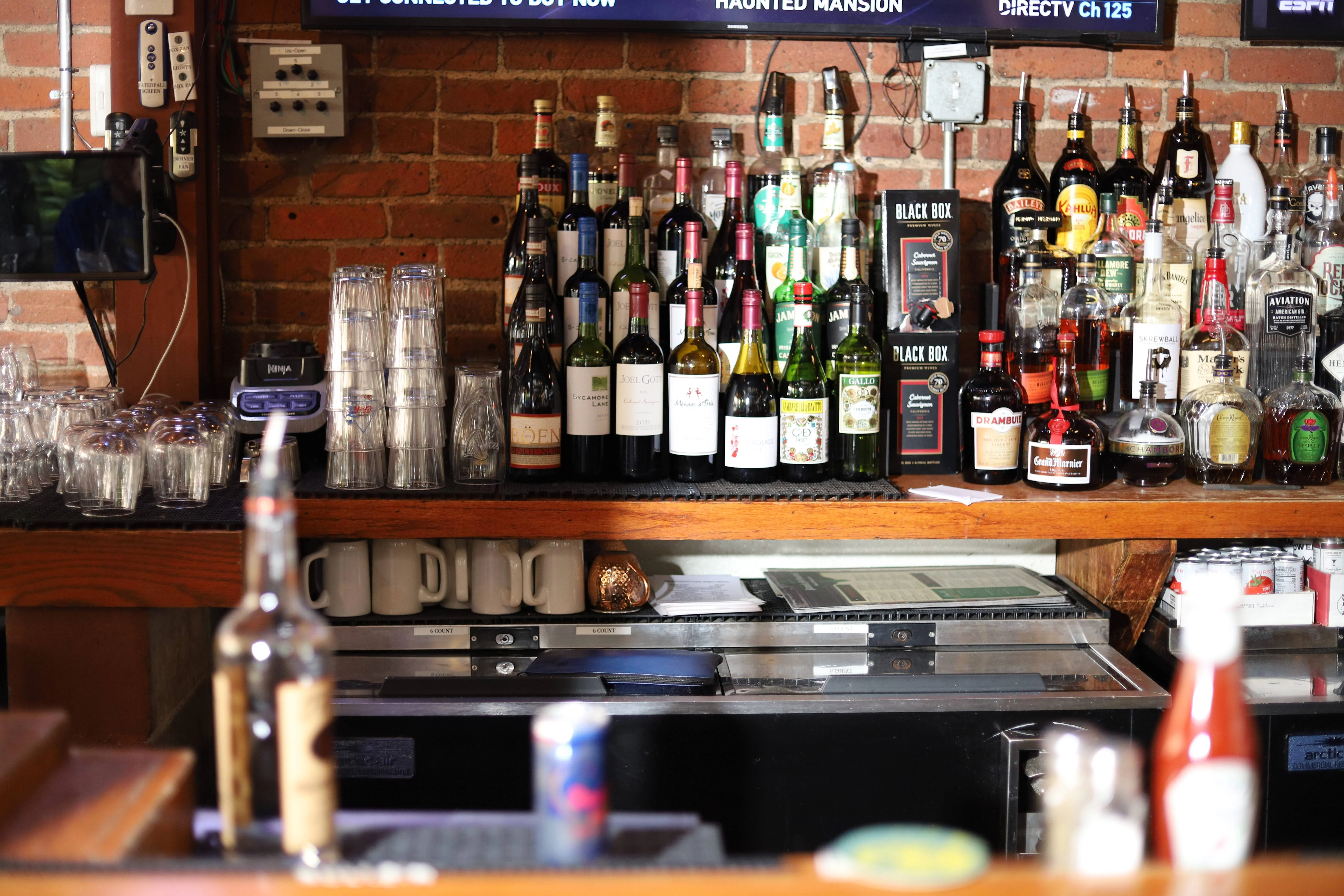 Fully stocked bar with mugs and wine bottles