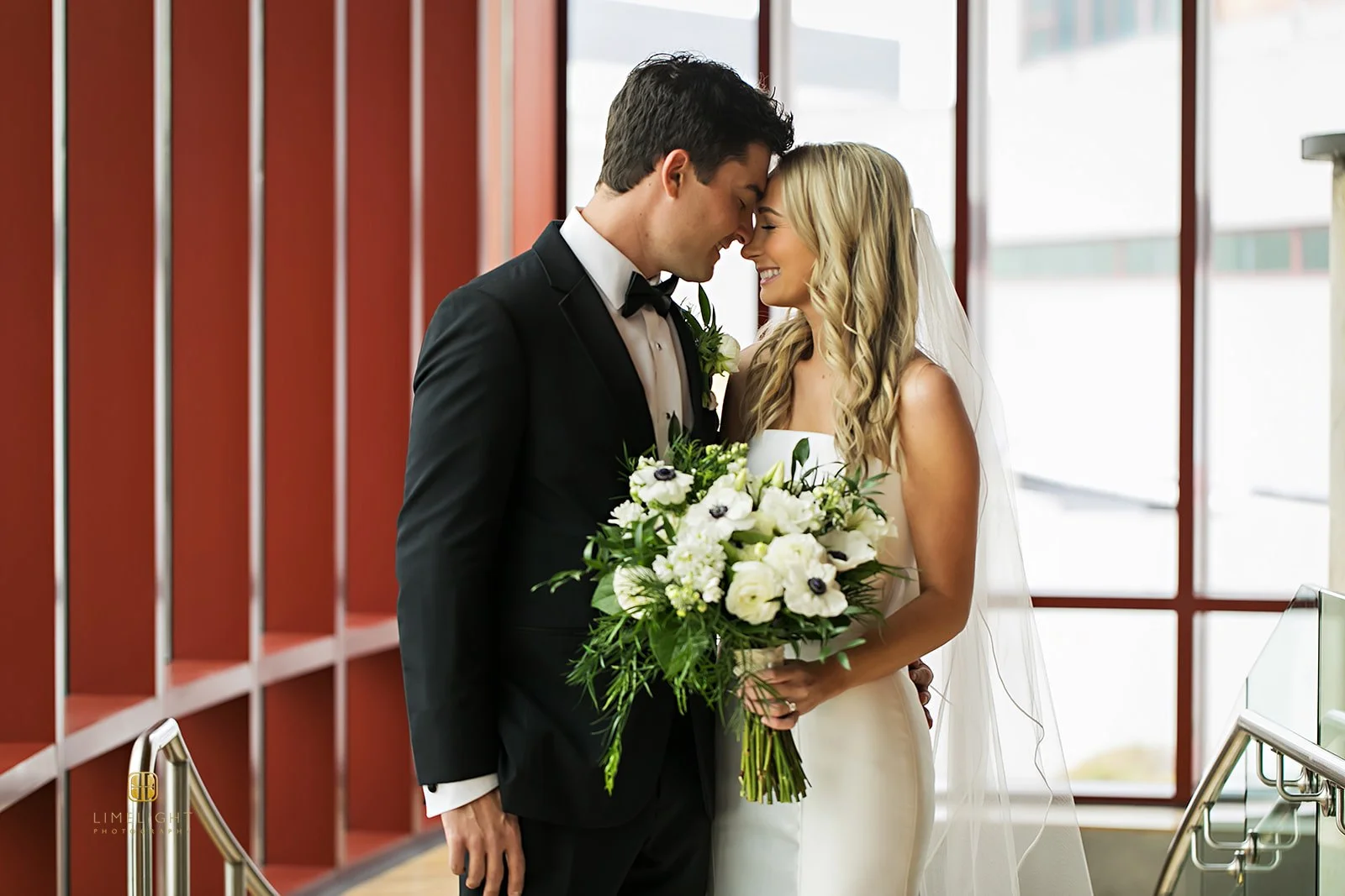 Bride and groom sharing a romantic moment indoors
