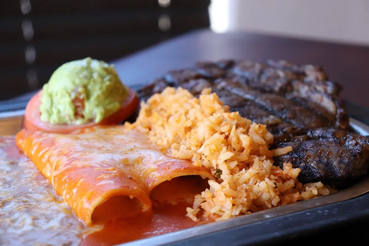 Mexican enchiladas with rice and grilled steak