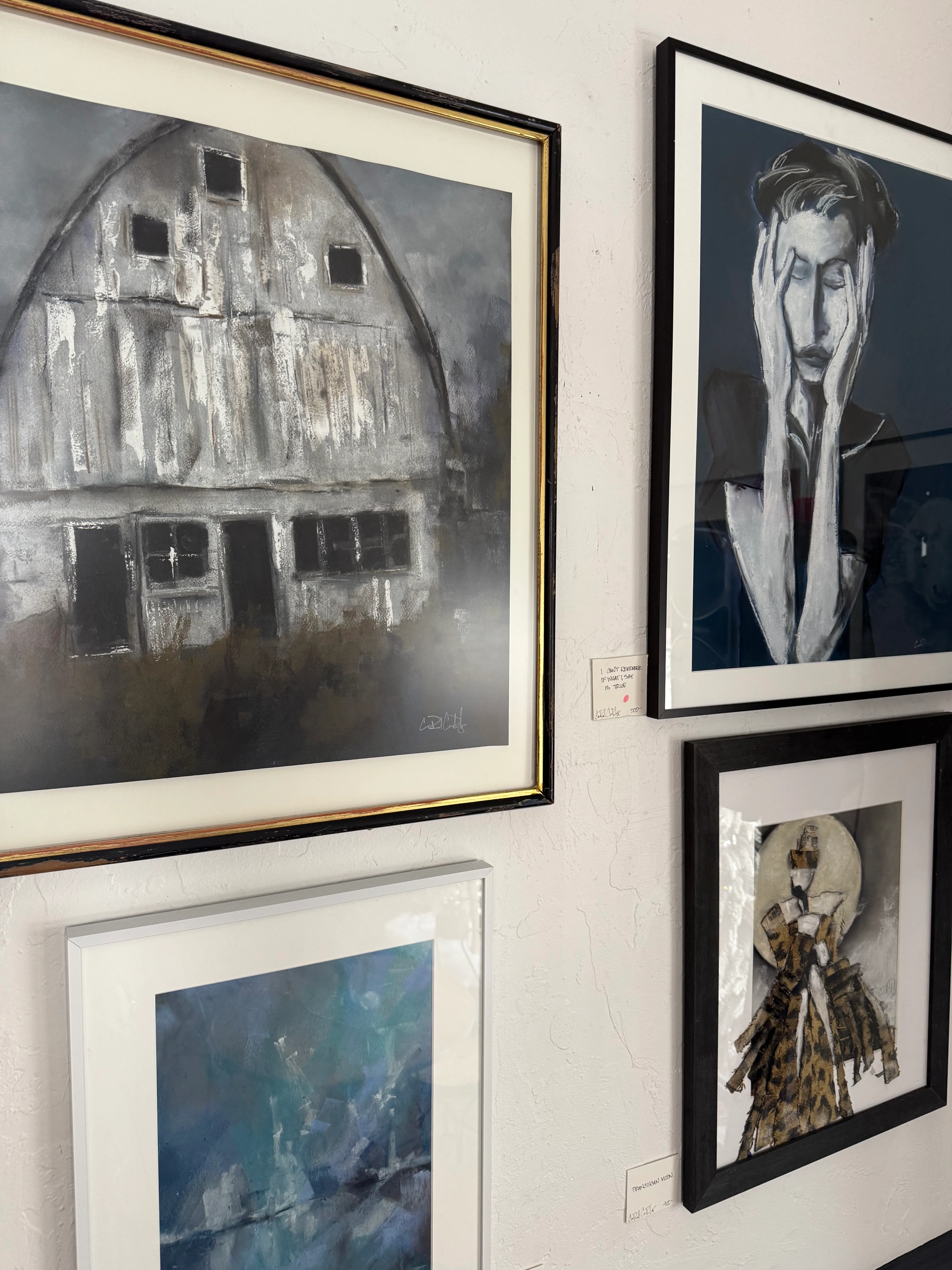Gallery wall featuring diverse artwork in various frames