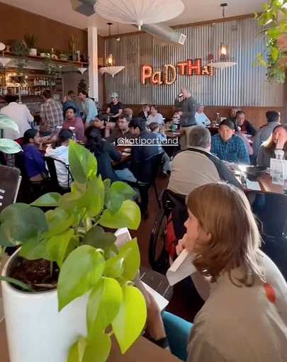 Lively restaurant interior with diners enjoying Thai cuisine