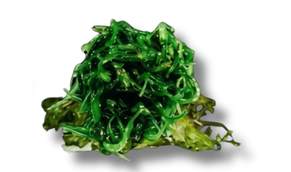 A mound of green seaweed salad on a bed of lettuce.