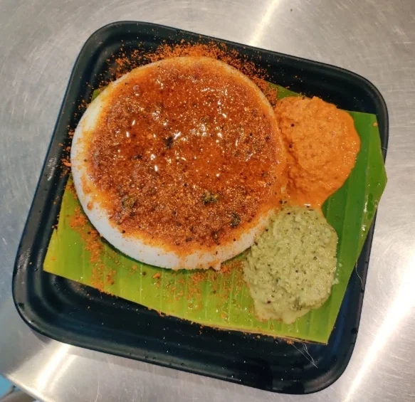 South Indian dosa served with chutneys on a banana leaf