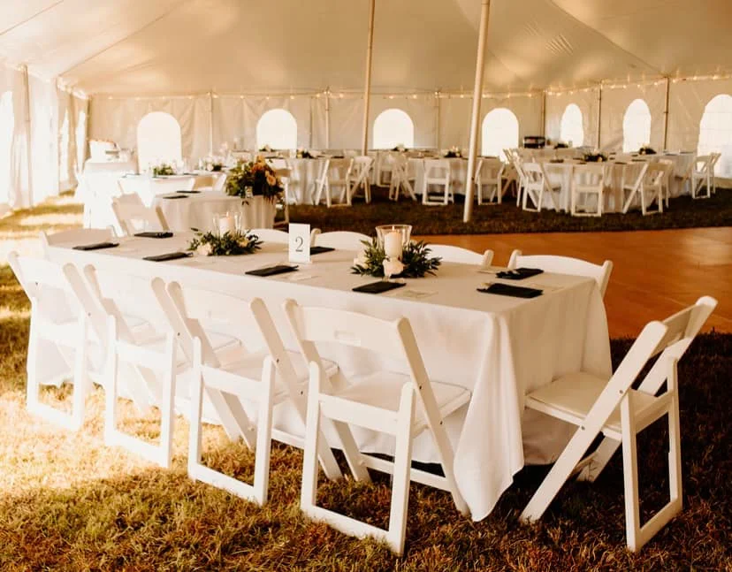 Elegant outdoor dining setup under a tent