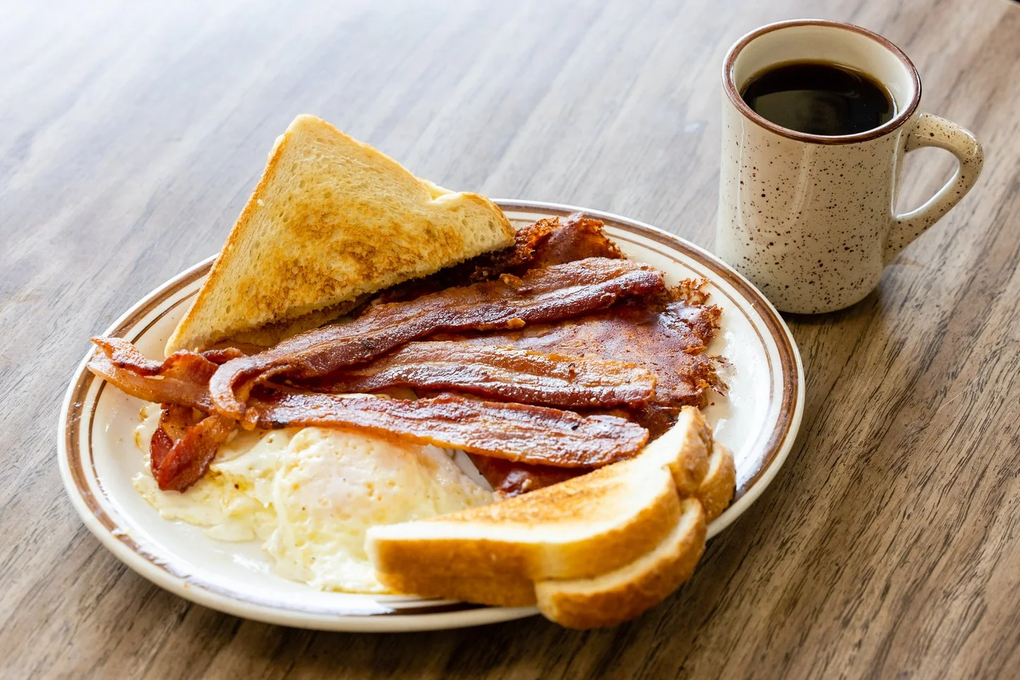 Classic American breakfast with bacon, eggs, and toast