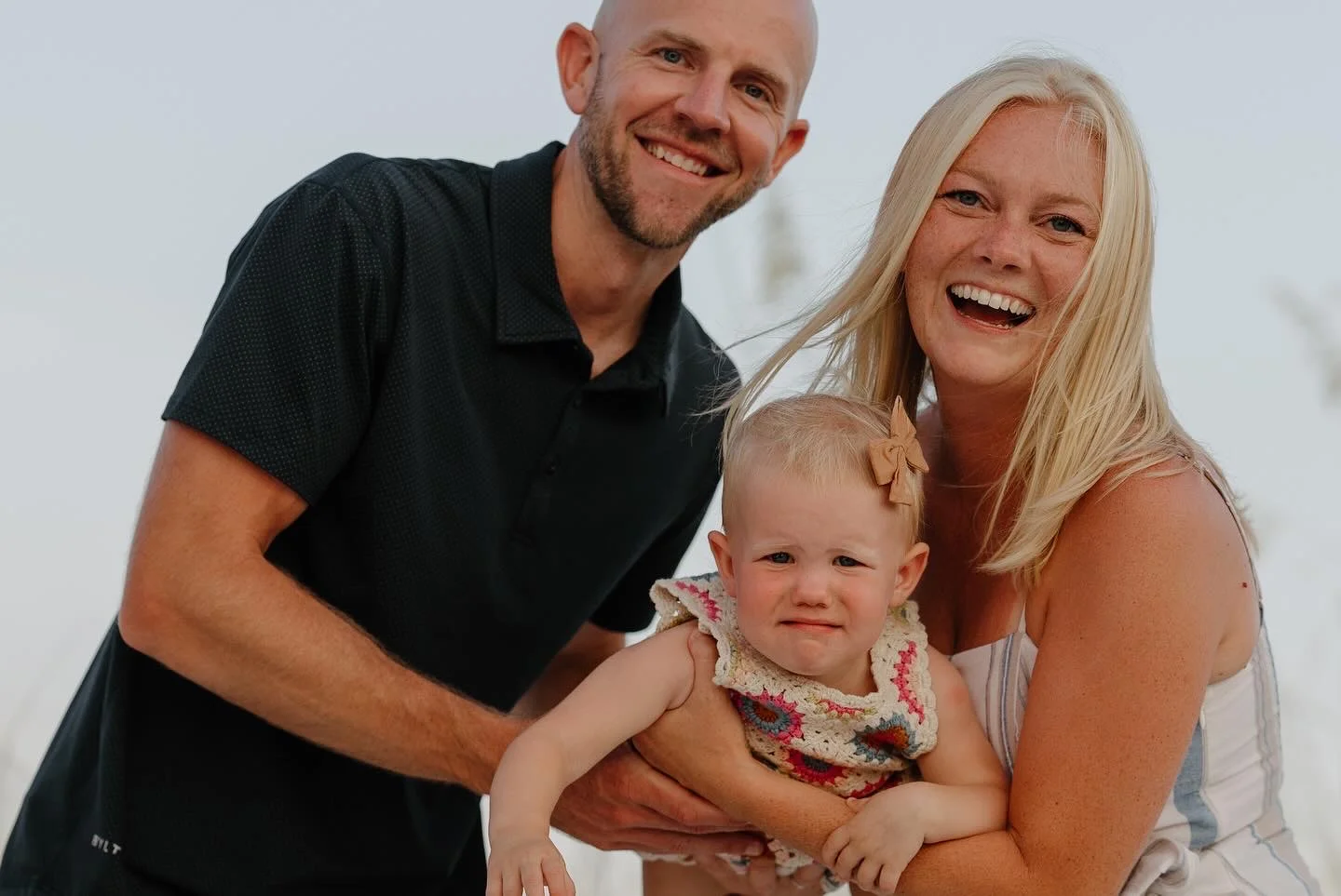 Family portrait with parents and baby outdoors