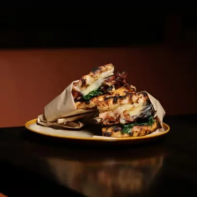 Grilled Italian panini with greens and meats