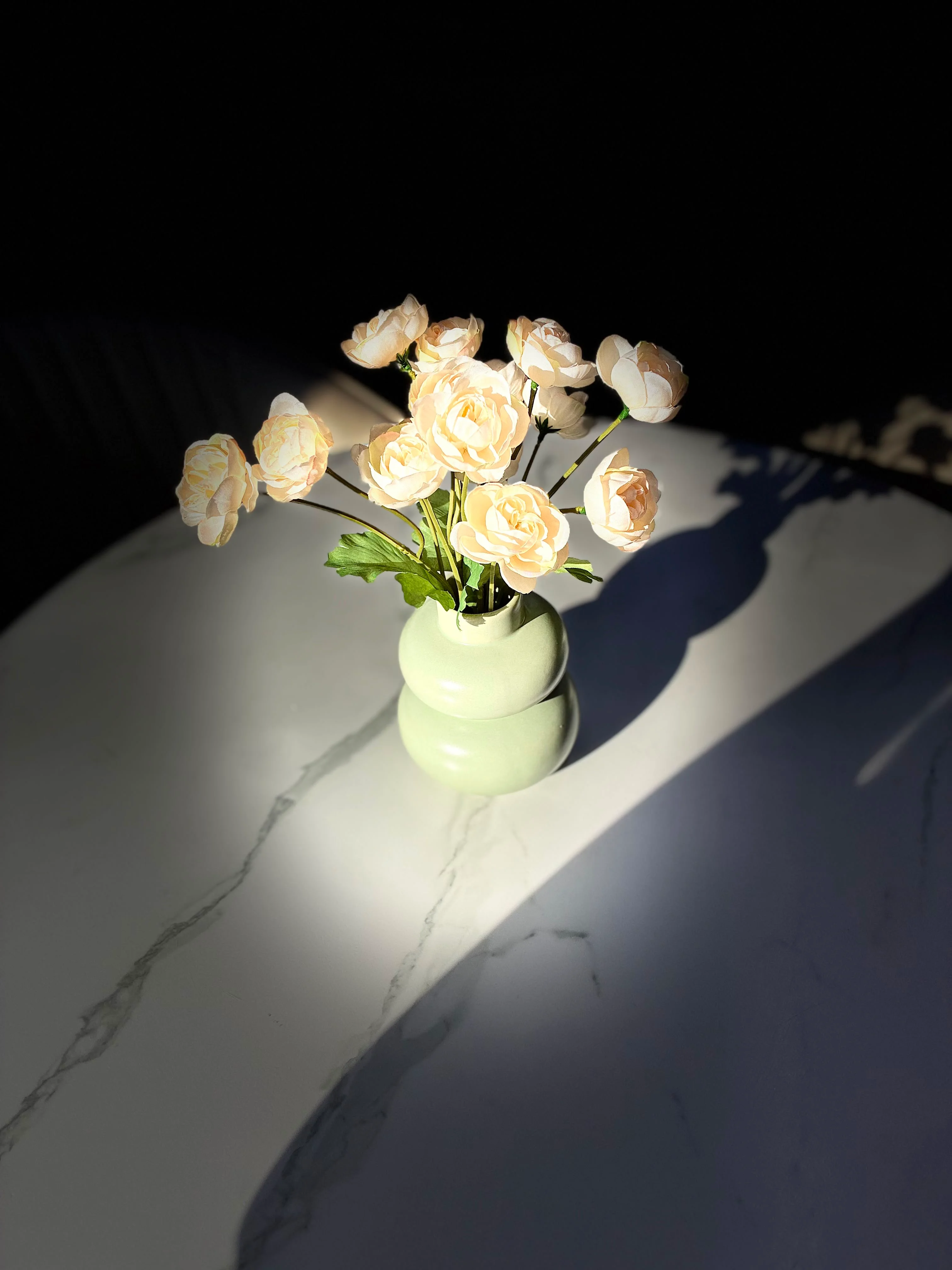 White rose bouquet in a vase on a marble surface