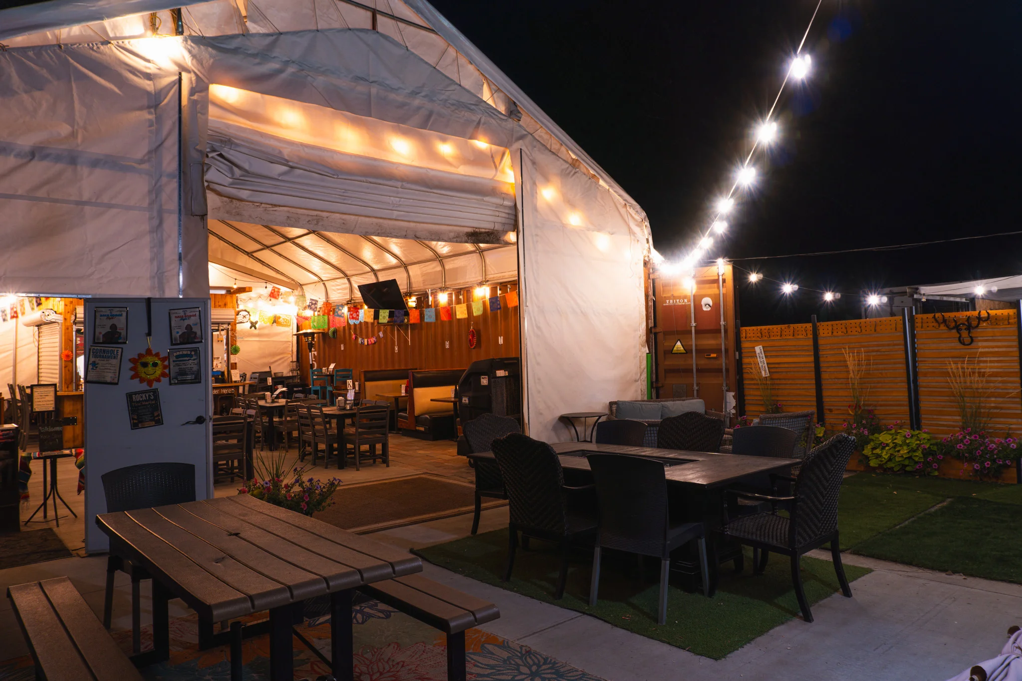 Cozy outdoor dining area with string lights and festive decor