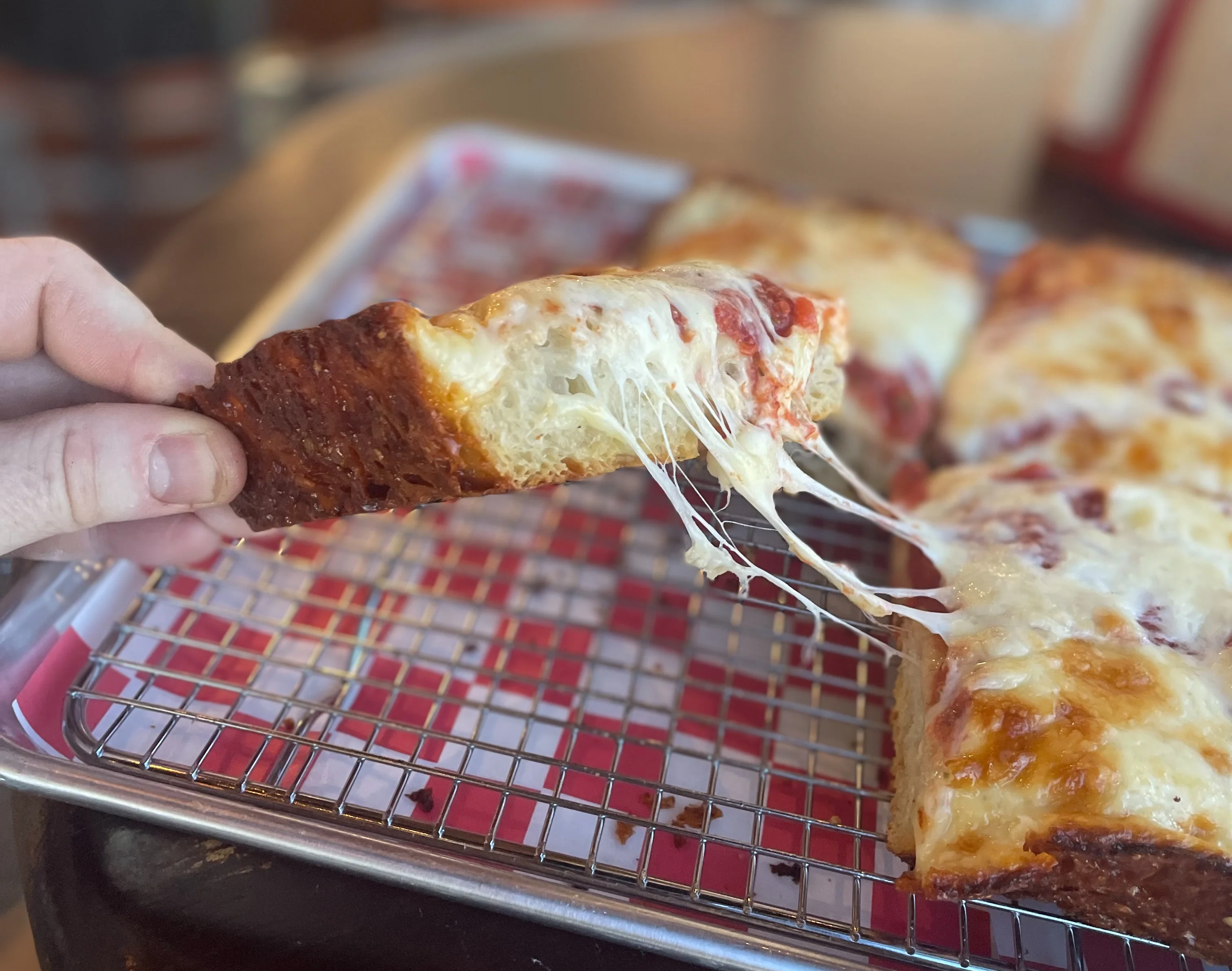 Cheesy Detroit-style pizza with a crispy crust