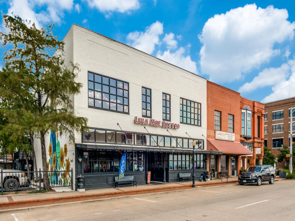Exterior view of Lula Mae Bistro with vibrant mural and open sign