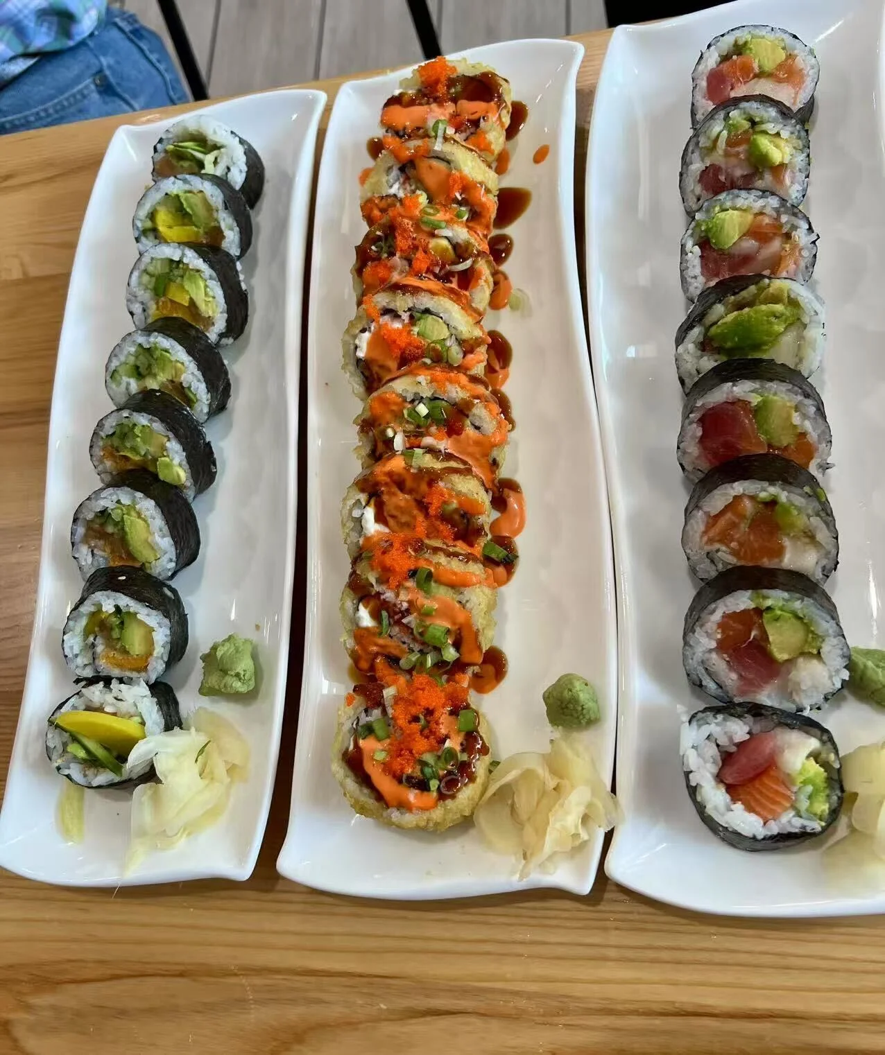 Assorted sushi rolls including California and spicy tuna rolls