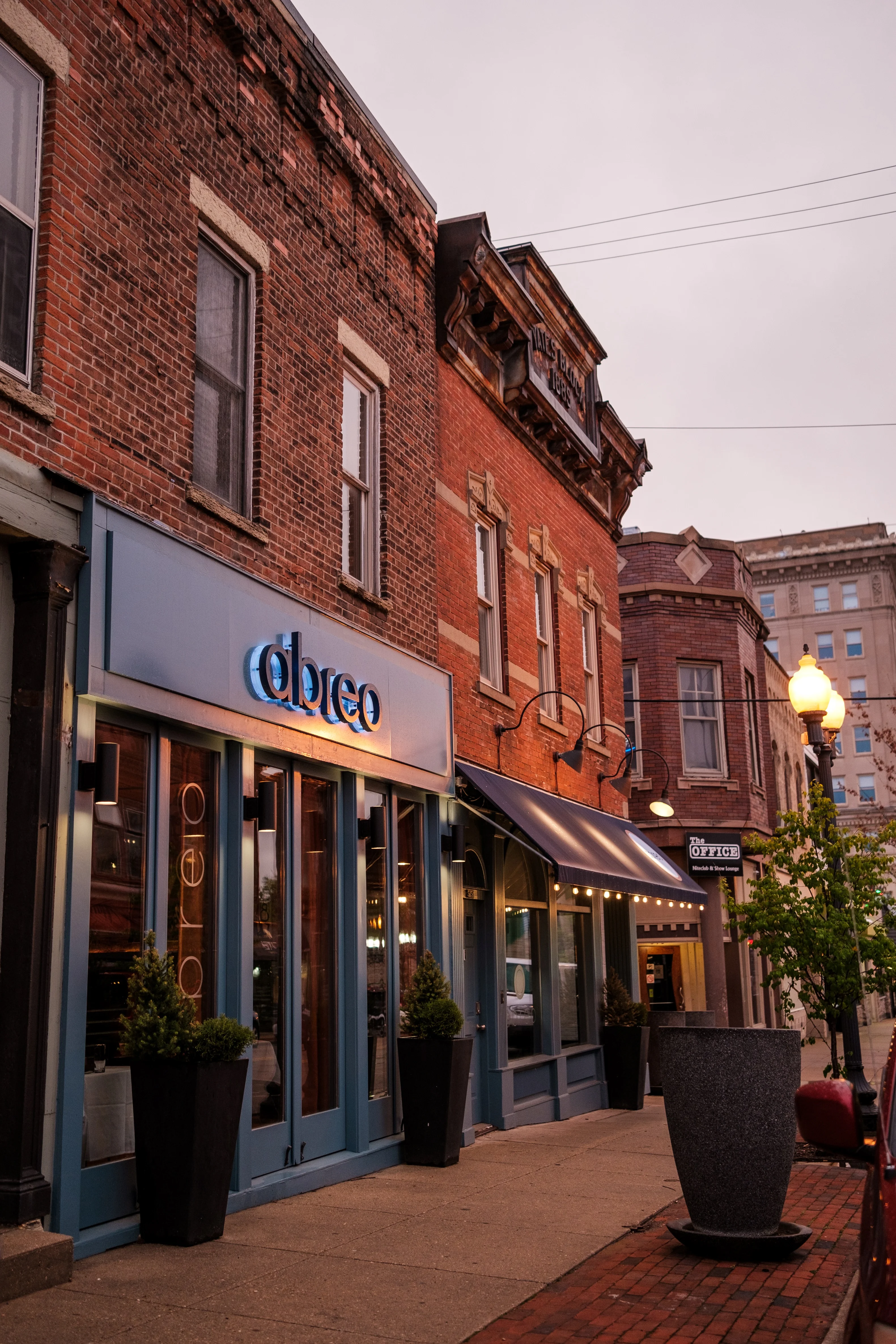 Charming restaurant exterior with warm lighting and brick architecture