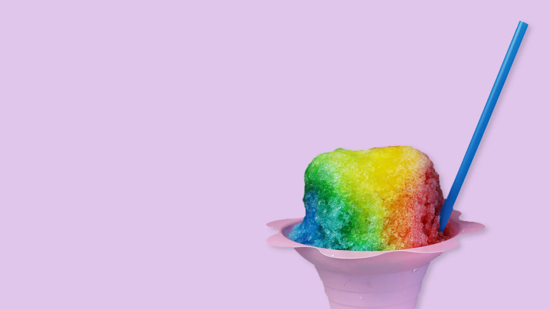 Colorful snow cone with various flavors in a cup