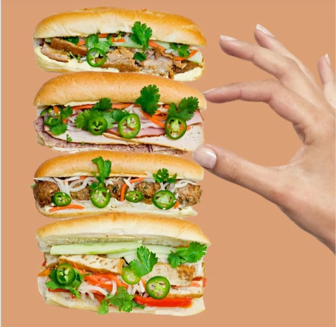 Vietnamese banh mi sandwiches stacked with fresh herbs