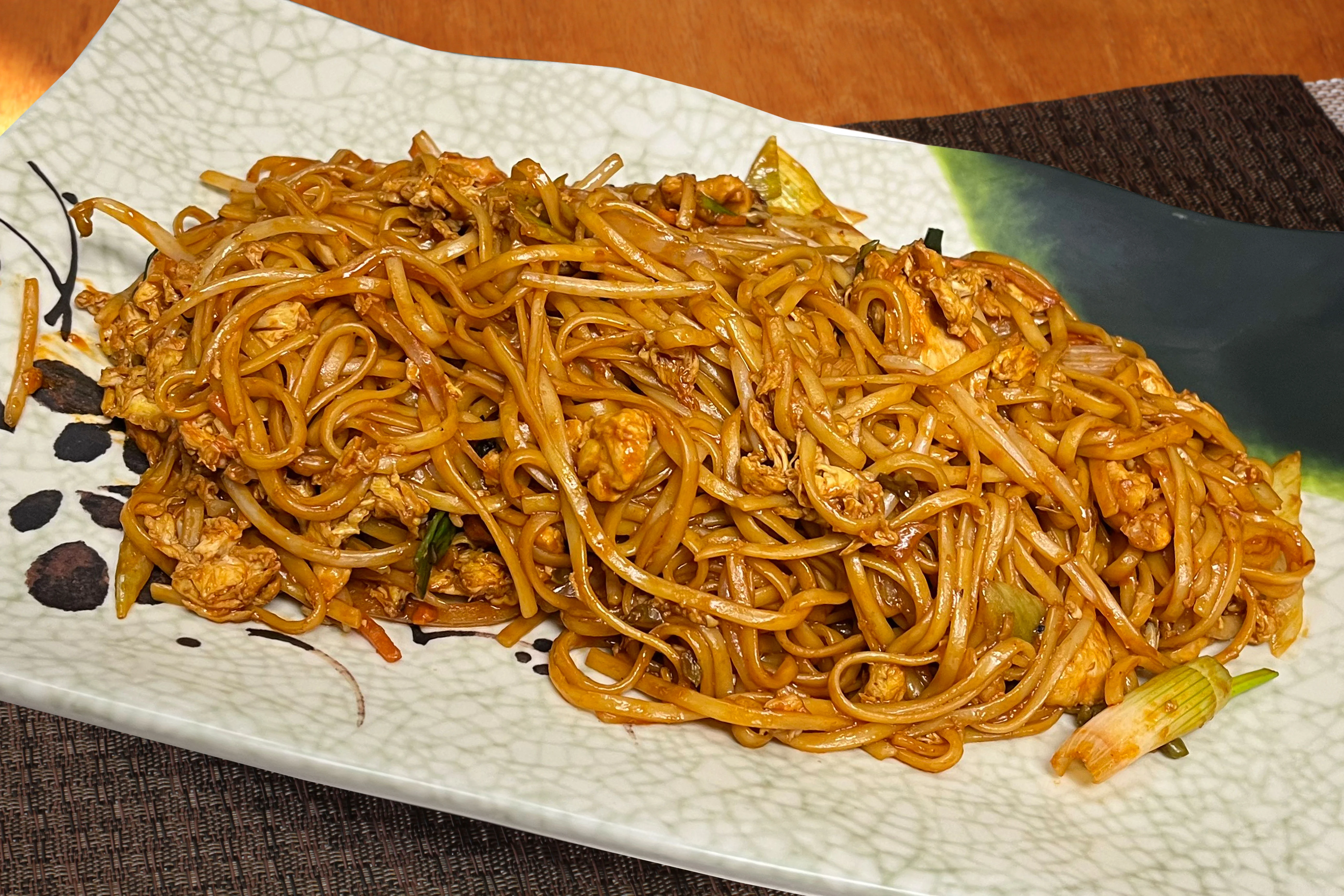 Plate of chicken chow mein with stir-fried noodles