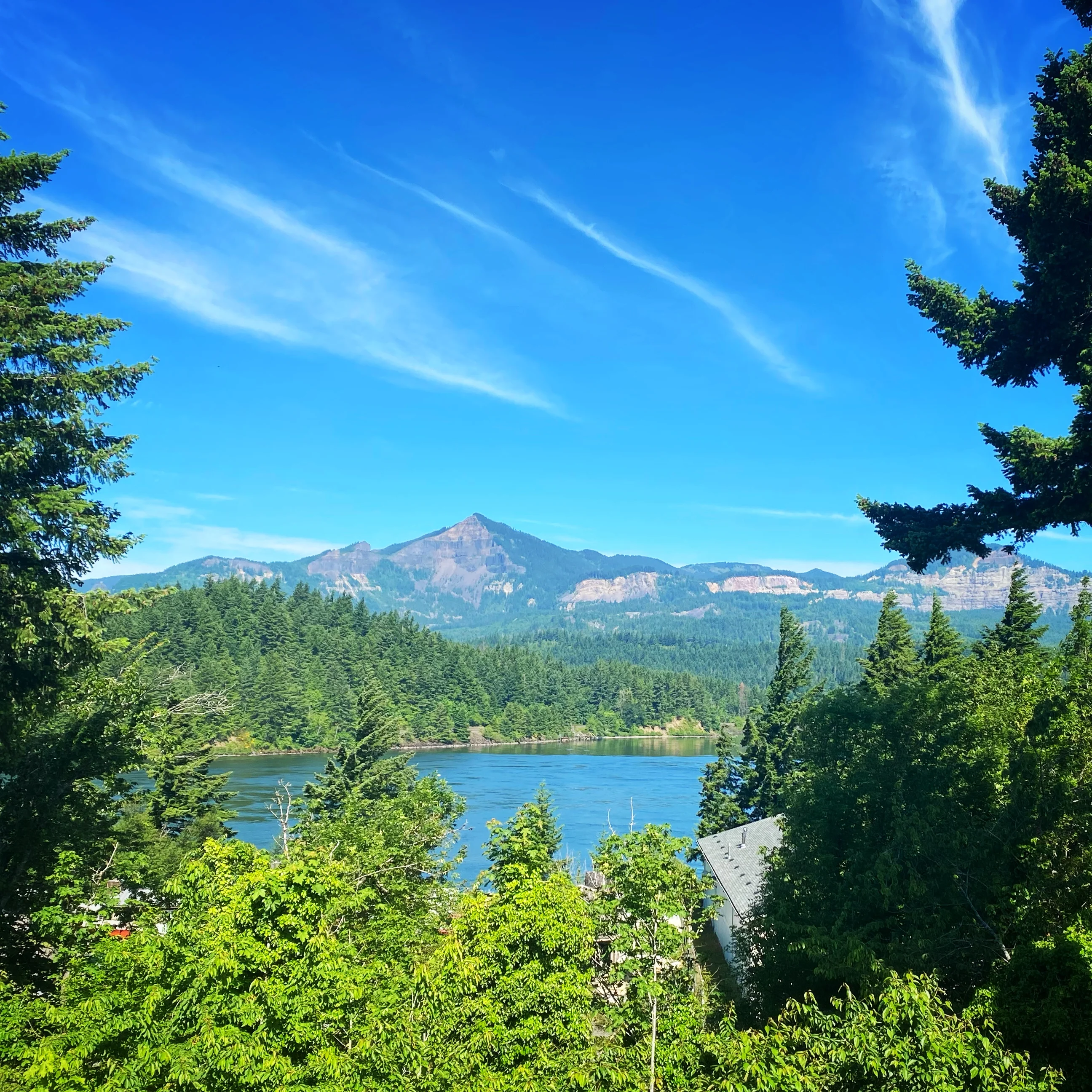 Scenic view of mountains and river under a clear blue sky