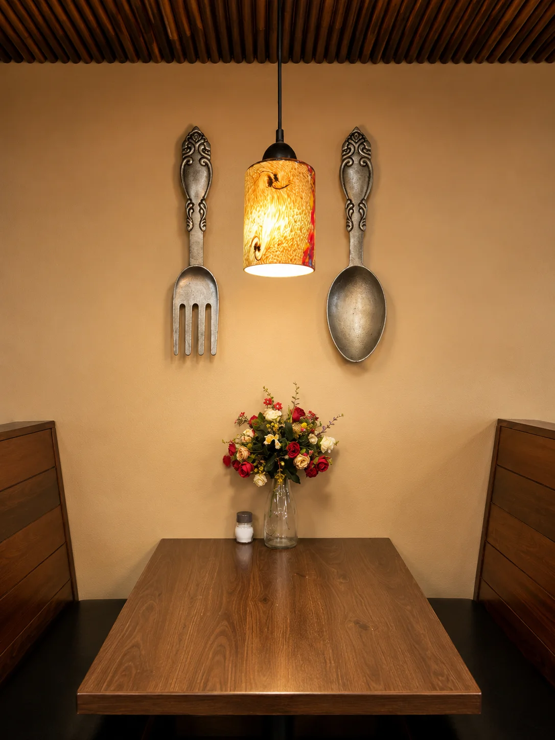 Cozy restaurant interior with decorative utensils and floral centerpiece
